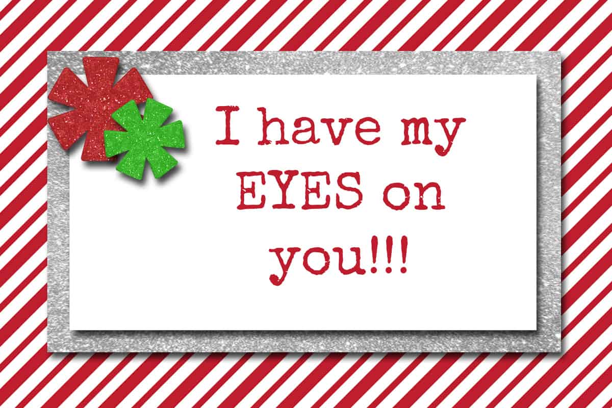 A festive greeting card with an elf on the shelf printables free pun, featuring the phrase "i have my eyes on you!!" with a decorative bow on top.