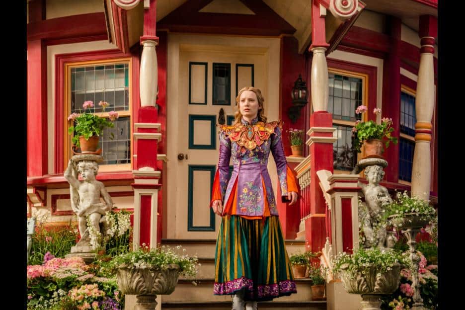 Mia Wasikowska standing in front of a building