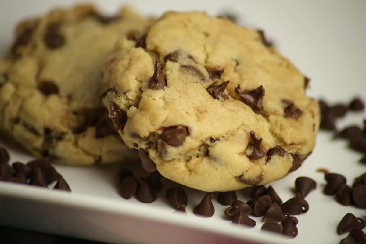 Chocolate chip cookies on a white plate.