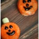 pumpkin Oreo cookies on a backdrop.