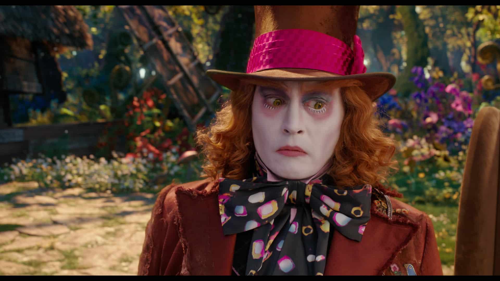A person wearing a purple hat talking on a cell phone, with Mia Wasikowska