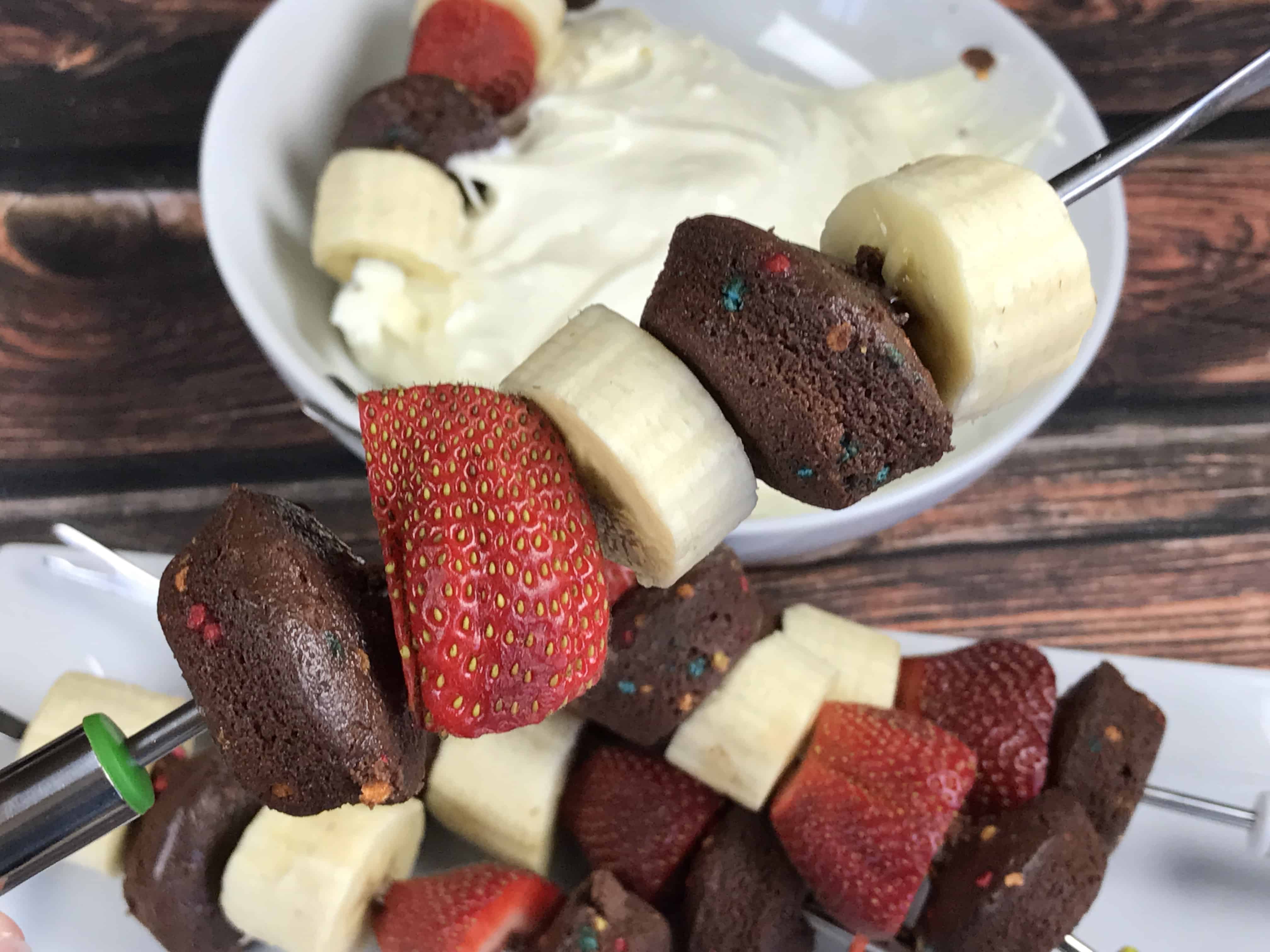 A plate of food with a slice of cake on a table, with Cream cheese