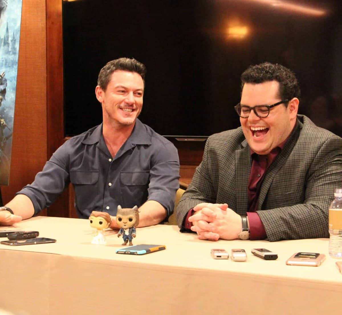 Luke Evans, Josh Gad sitting at a table