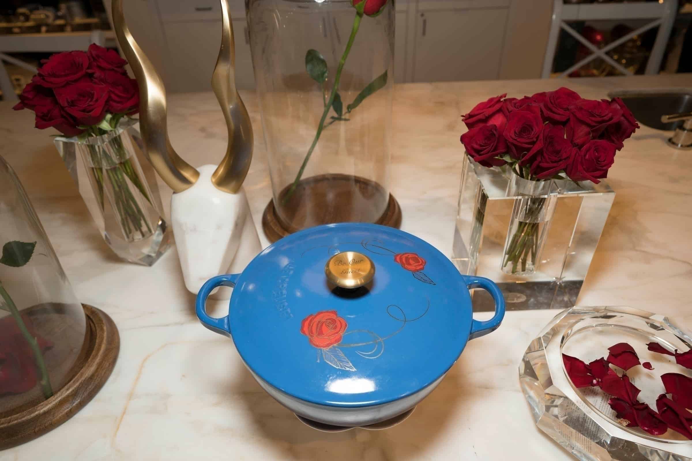 A kitchen with a blue bowl on a table, with Beauty and Le Creuset