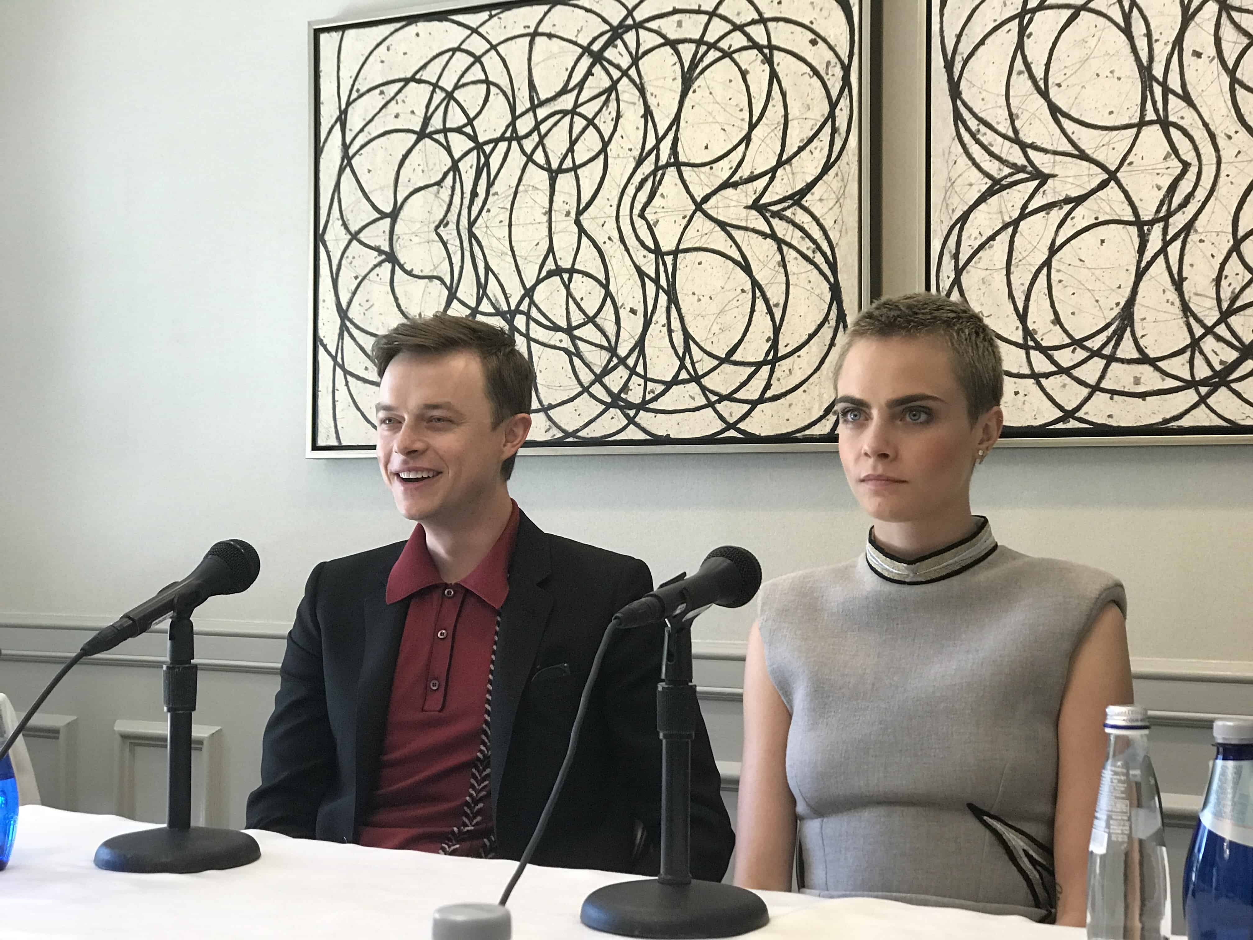 Dane DeHaan, Cara Delevingne sitting at a table