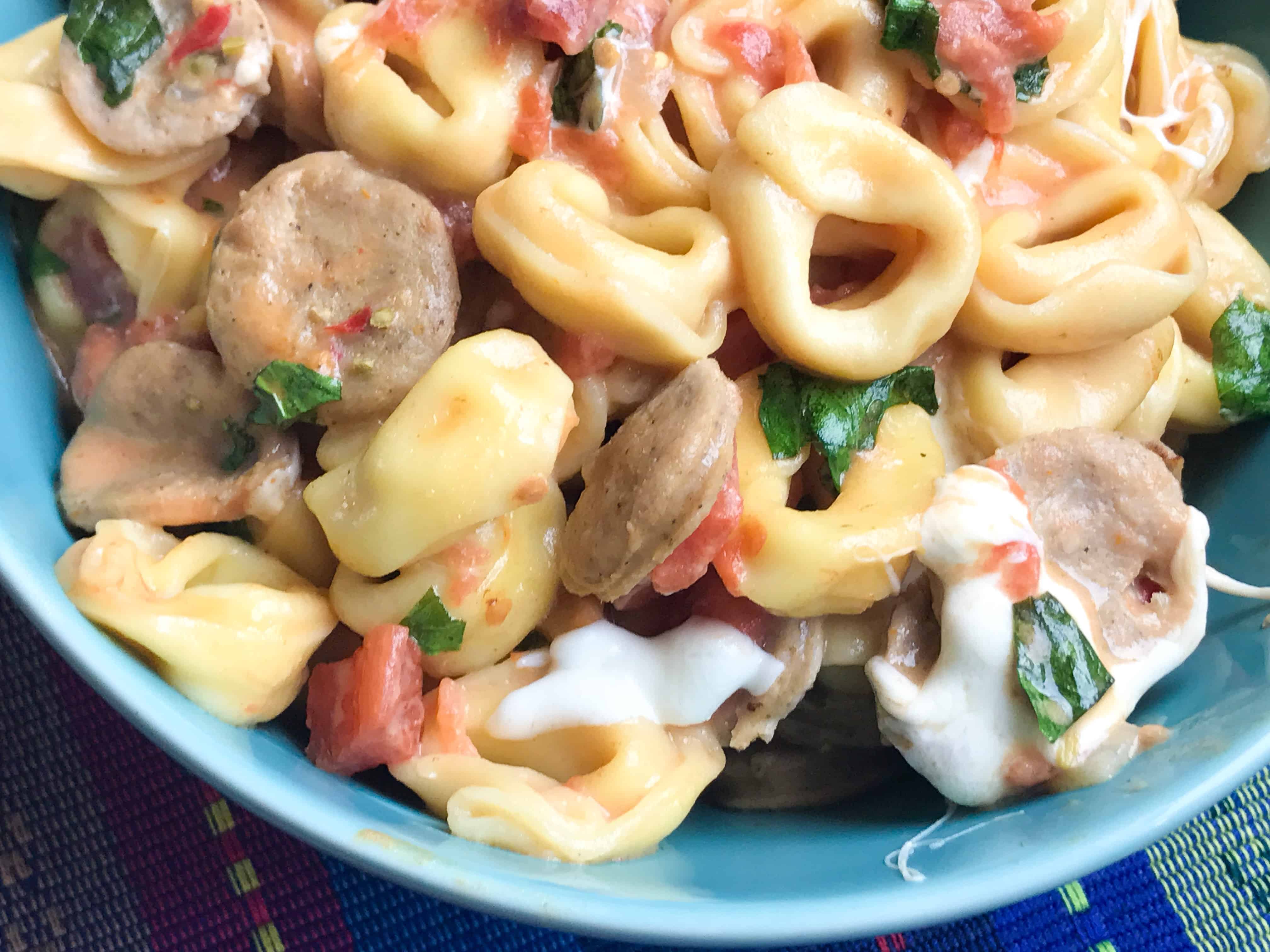 A dish is filled with food, with Chicken and Sausage