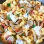 A dish is filled with food, with Chicken and Sausage
