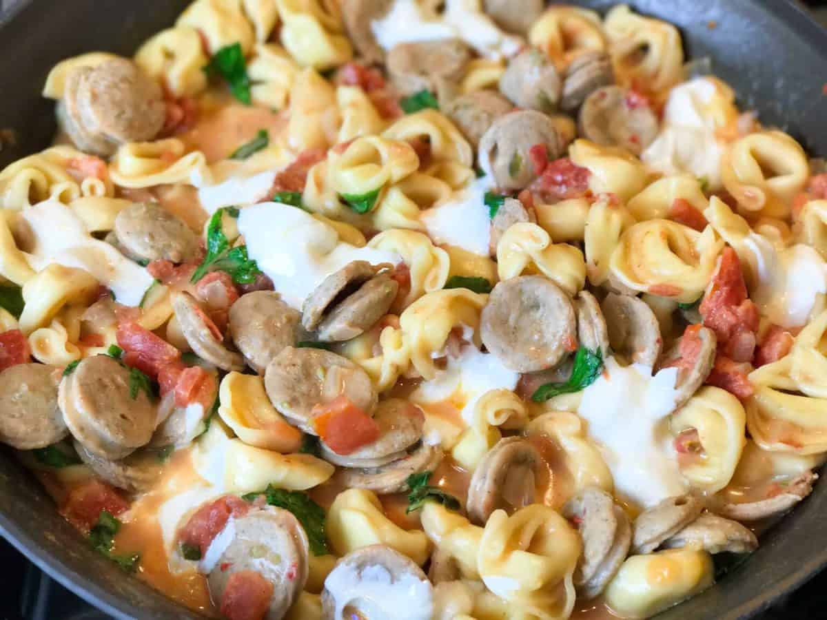 A dish is filled with food, with Chicken and Sausage