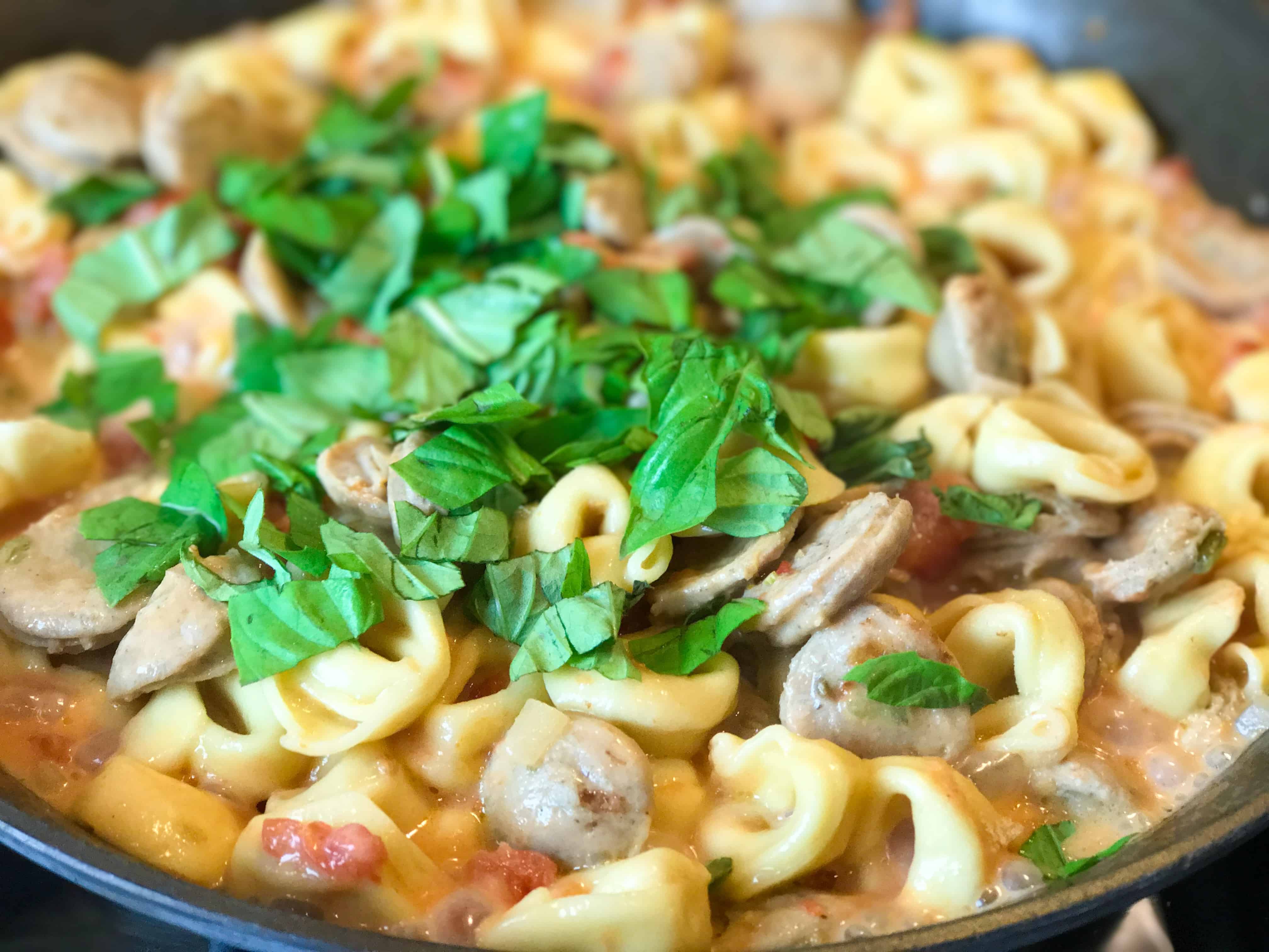 A bowl of food, with Chicken and Sausage