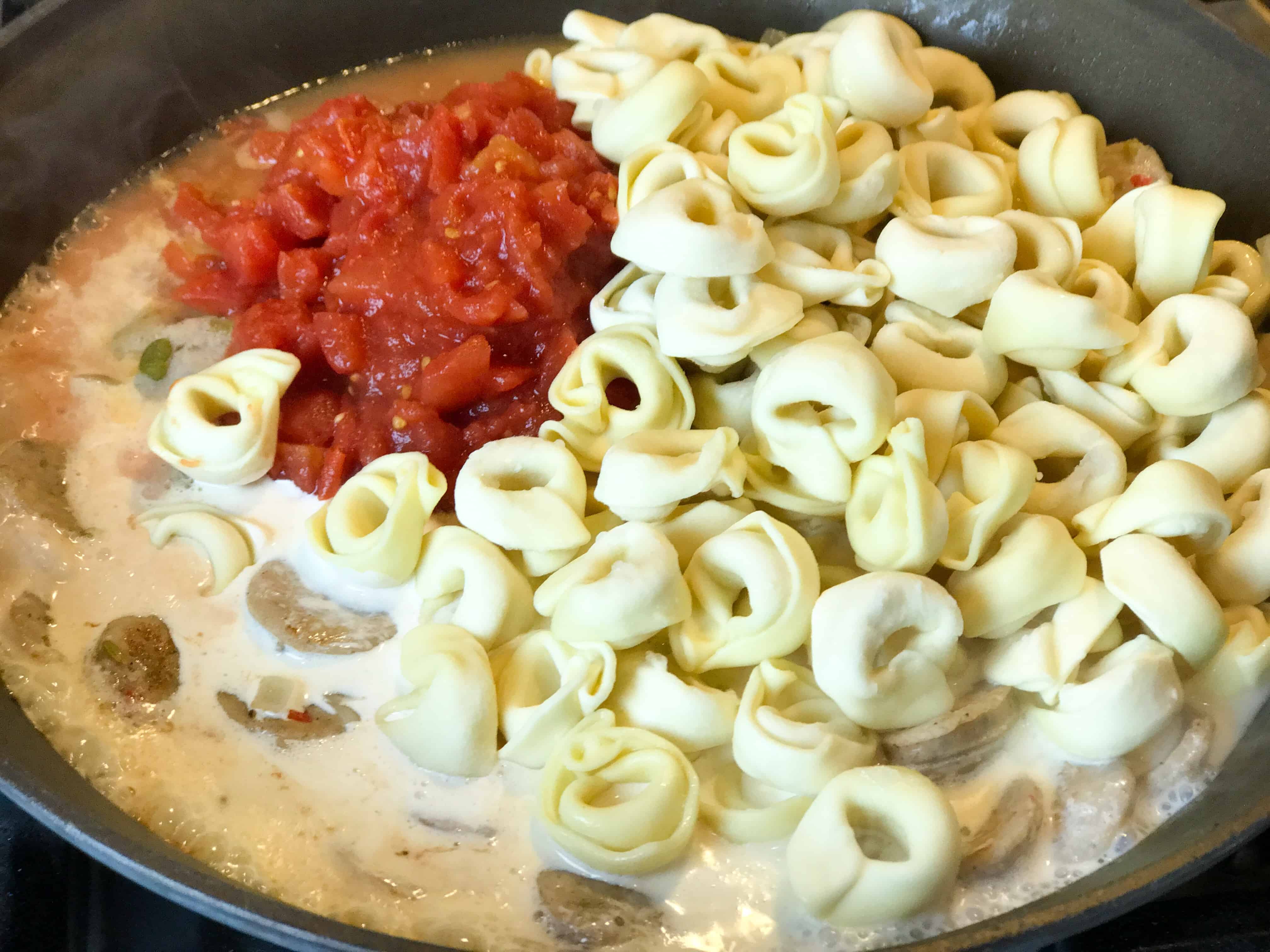 A bowl of food, with Chicken and Sausage