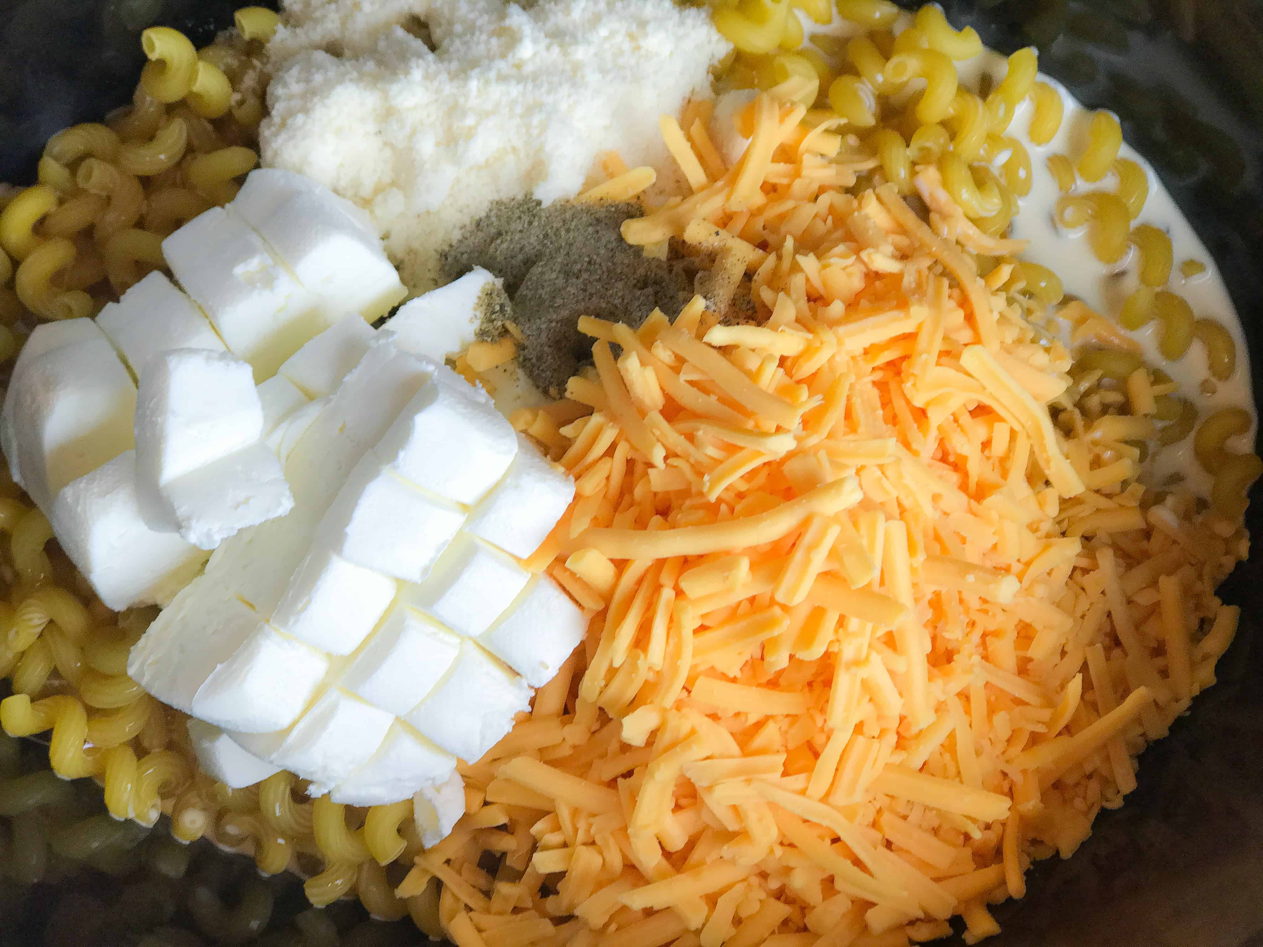 A close up of a plate of food with rice and vegetables, with Cheese