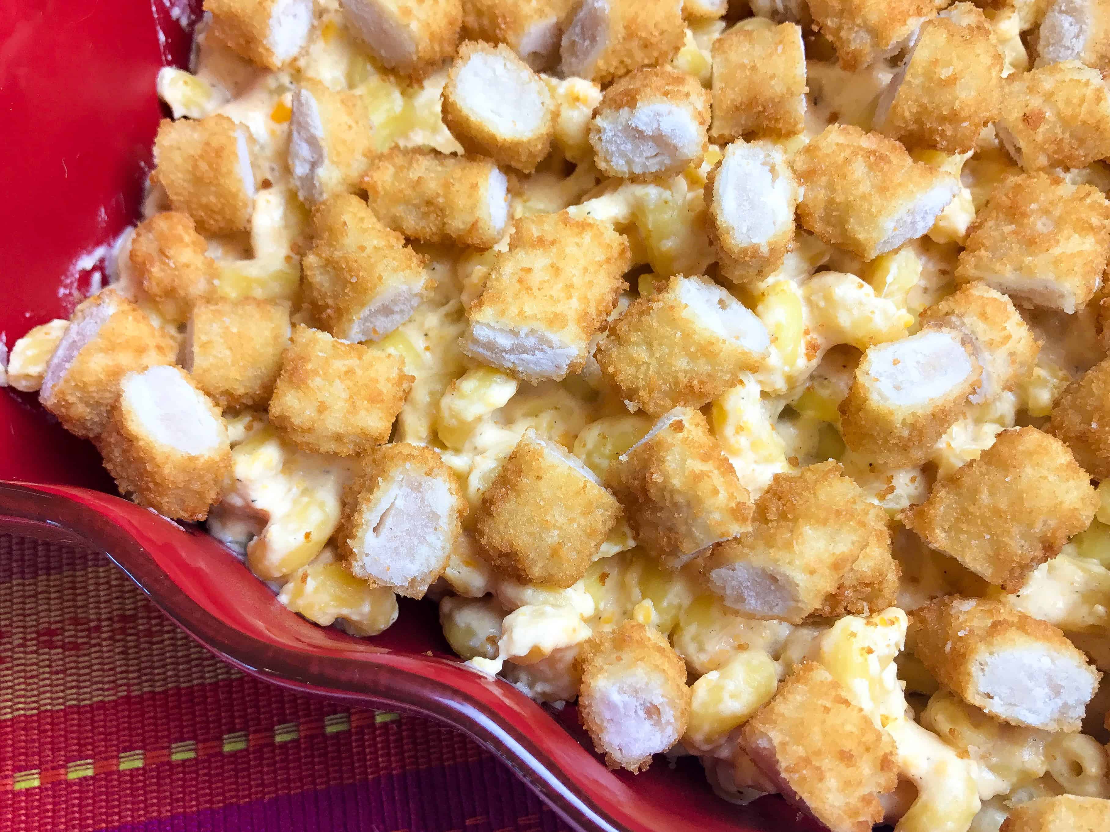 A dish is filled with food, with Cheese and Bread