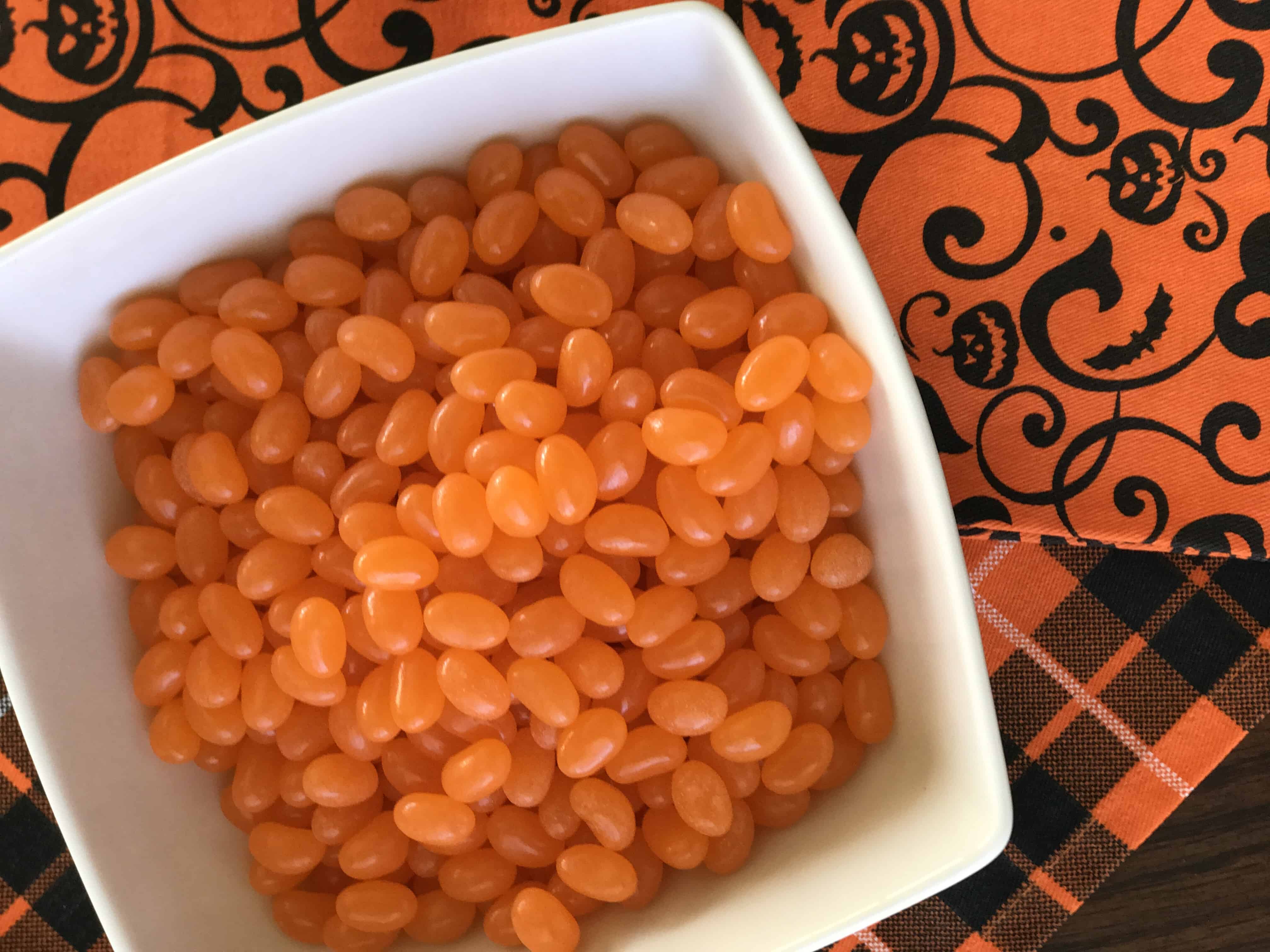 A bowl of food on a plate, with Jelly bean