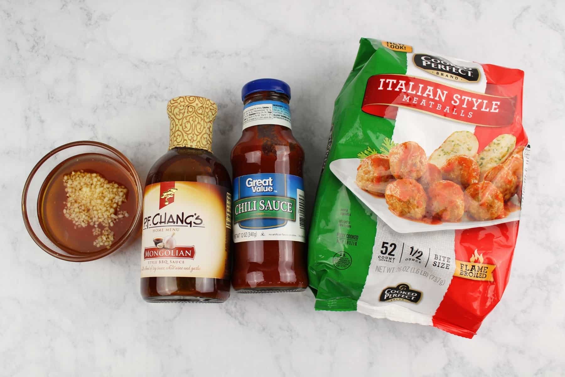 A tray of food and a bottle, with Meatball and Garlic