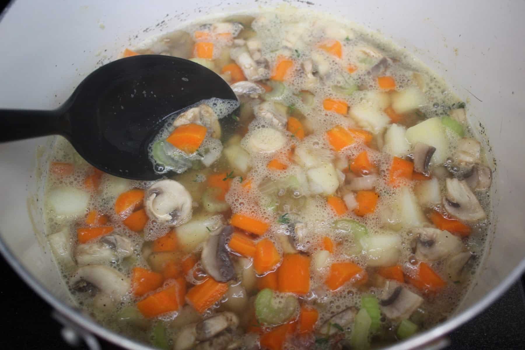 A bowl of soup and a spoon