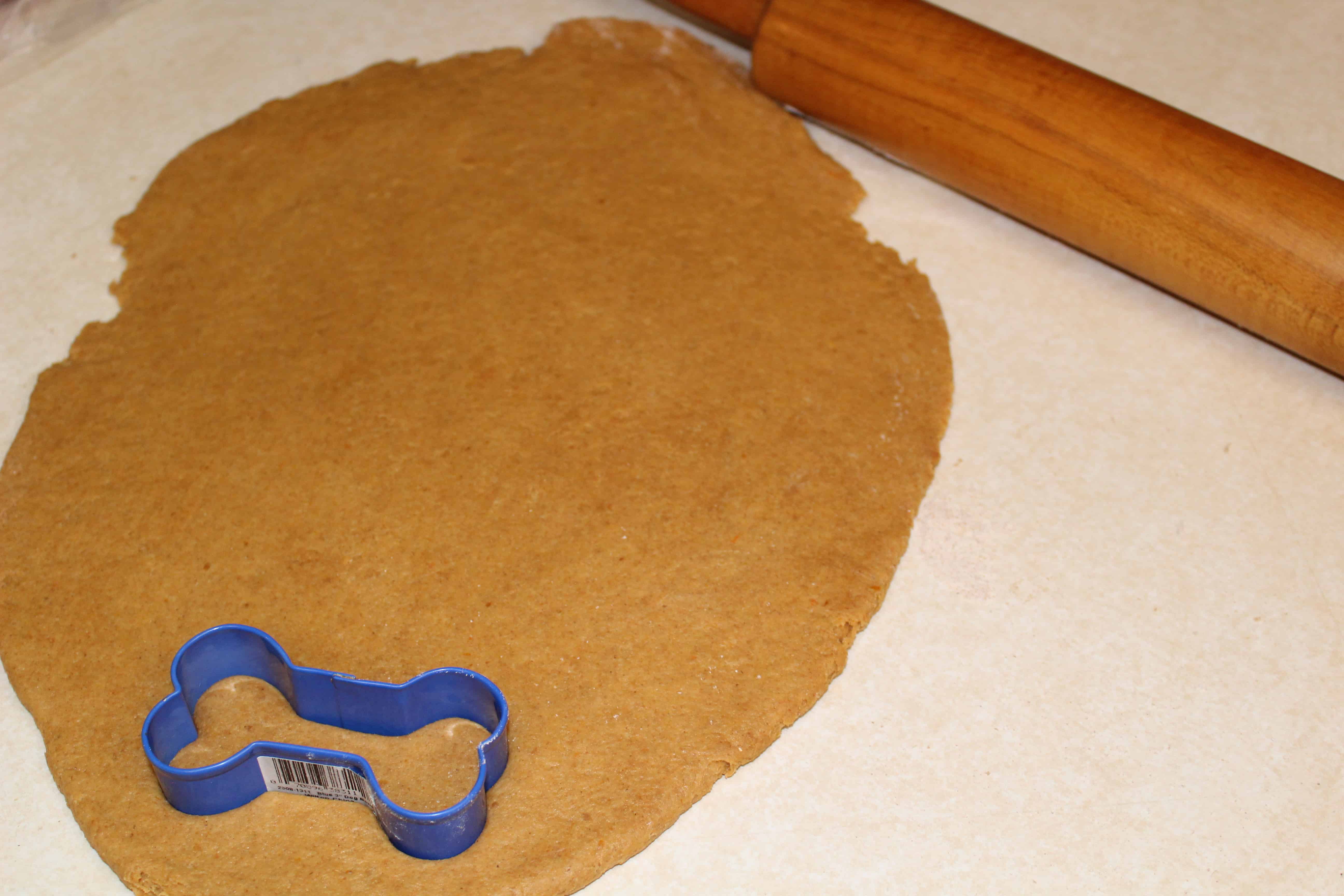 dog biscuit dough on a cutting board, with Dog and Biscuit
