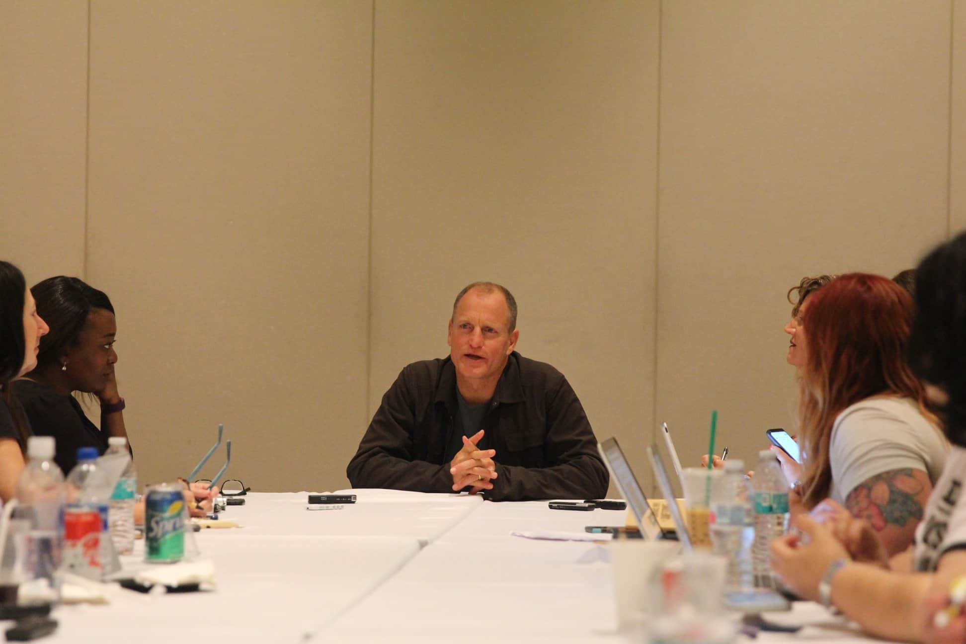 Woody Harrelson et al. sitting at a table