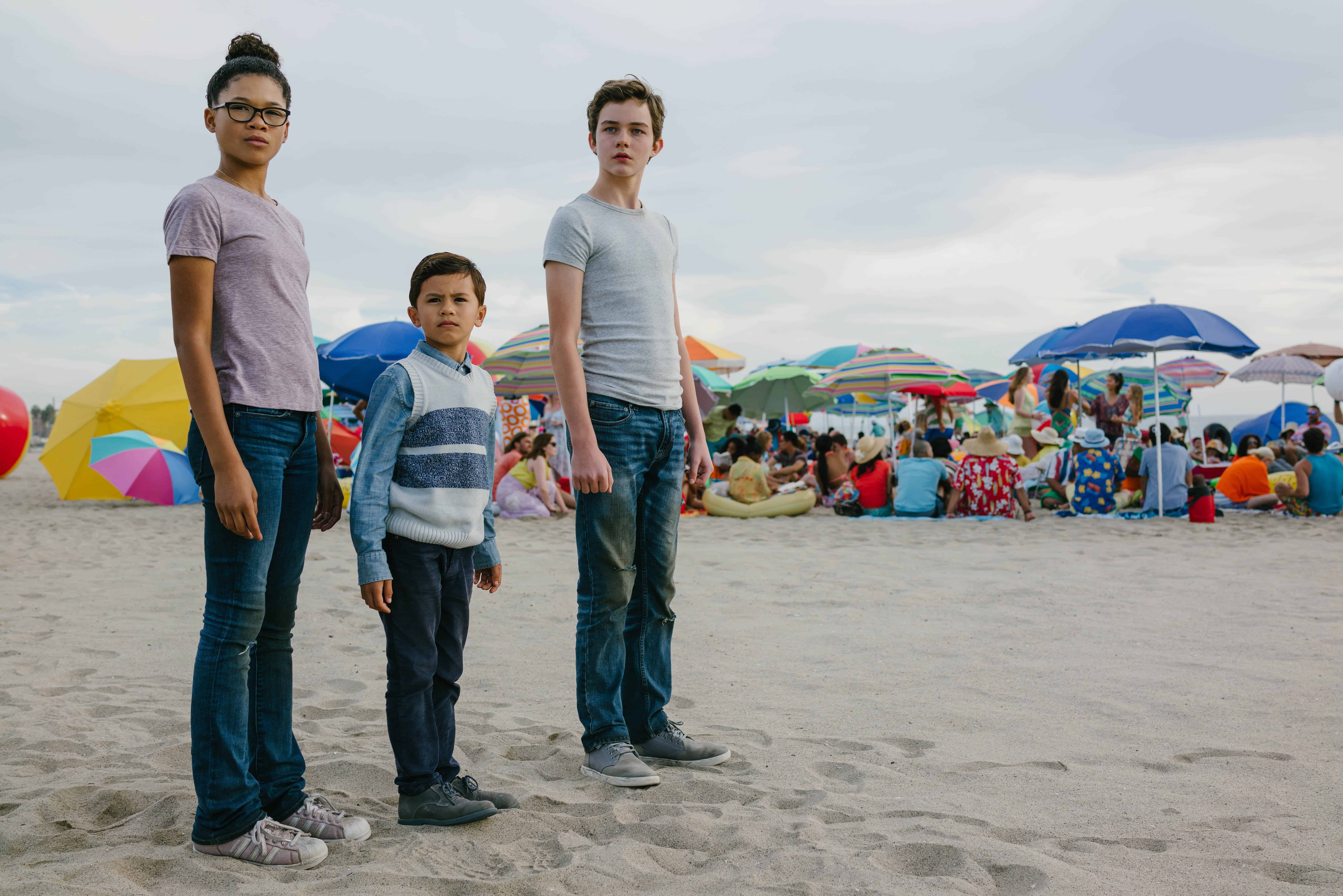 Storm Reid, Levi Miller standing on top of a sandy beach