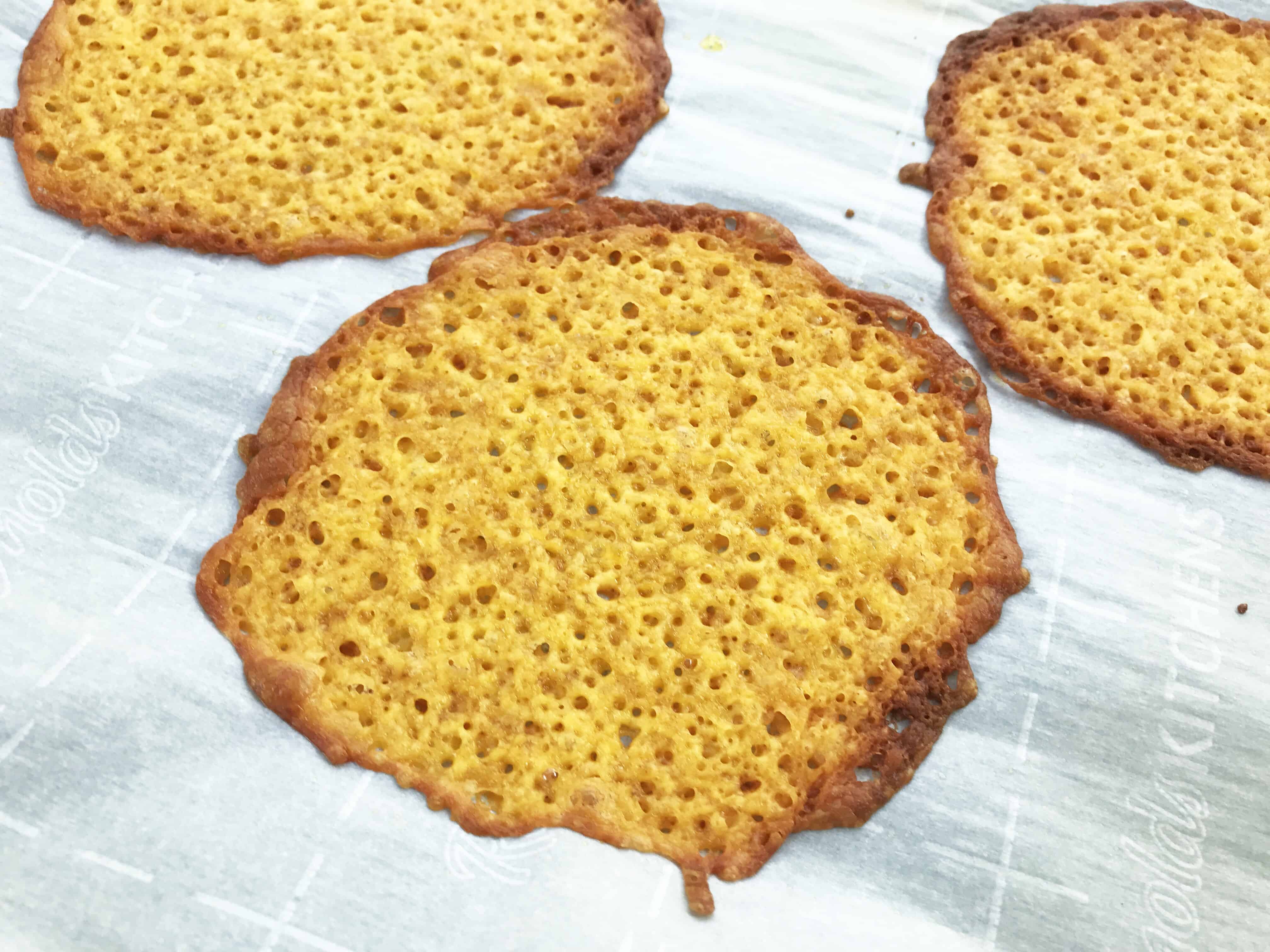 A piece of cheese on a plate, with Taco and Cheese