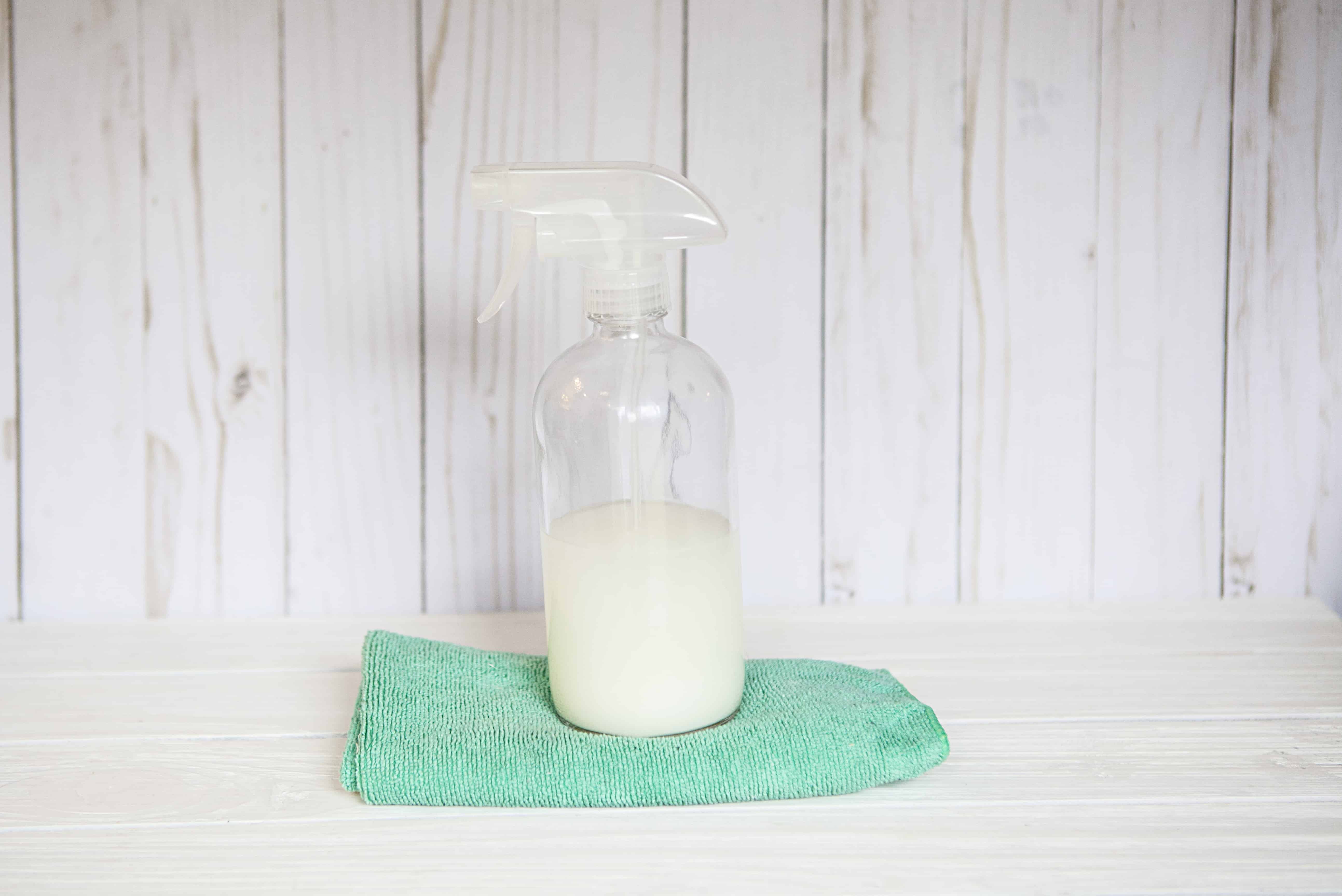 Enjoy a streak free shine or all your glass and mirrors with this easy DIY Streak Free Glass Cleaner. This homemade cleaner is perfect for a clean home. #diyglasscleaner #streakfreeglasscleaner bottle on rag