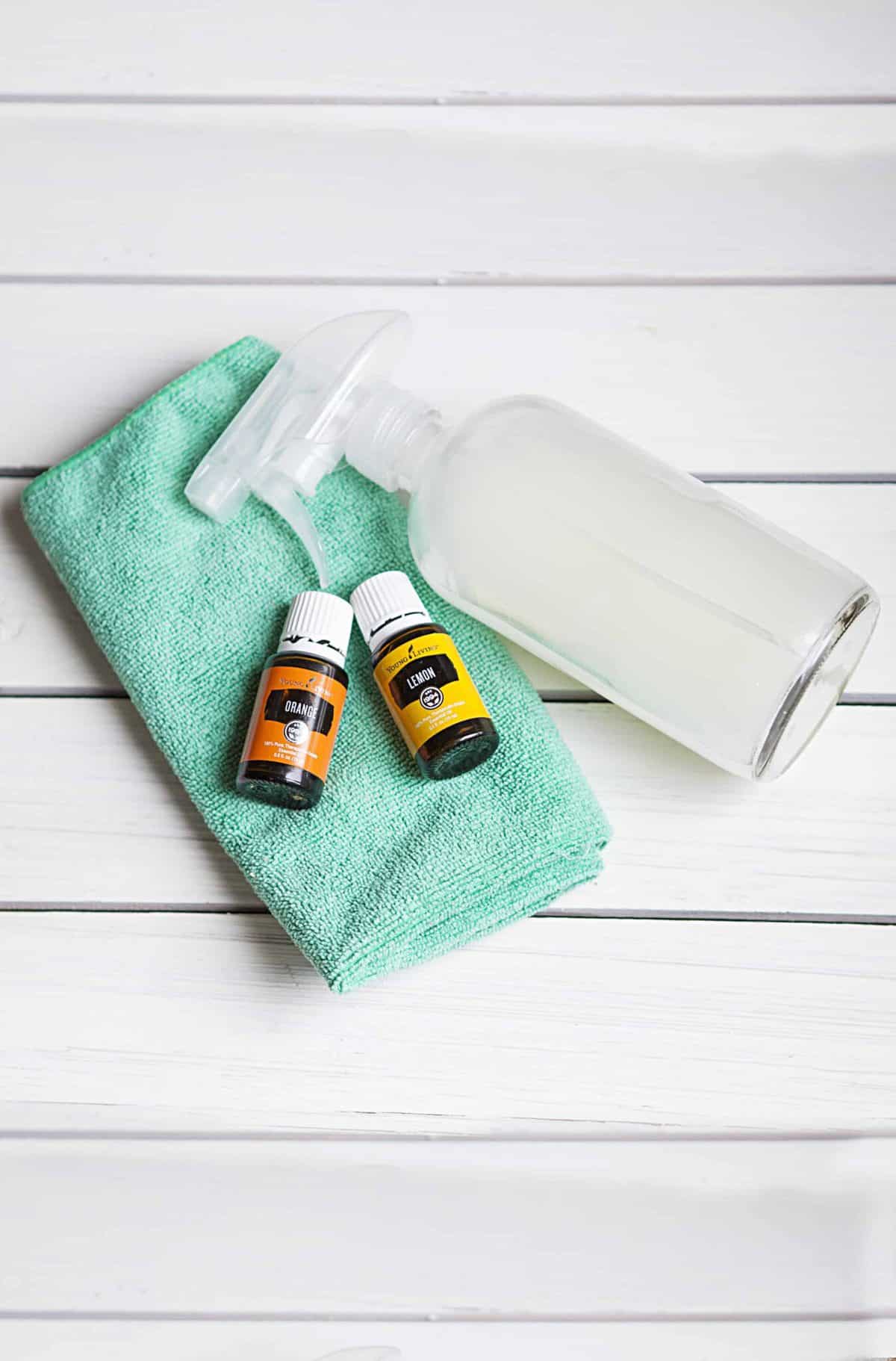 Enjoy a streak free shine or all your glass and mirrors with this easy DIY Streak Free Glass Cleaner. This homemade cleaner is perfect for a clean home. #diyglasscleaner #streakfreeglasscleaner Cleaning ingredients on table