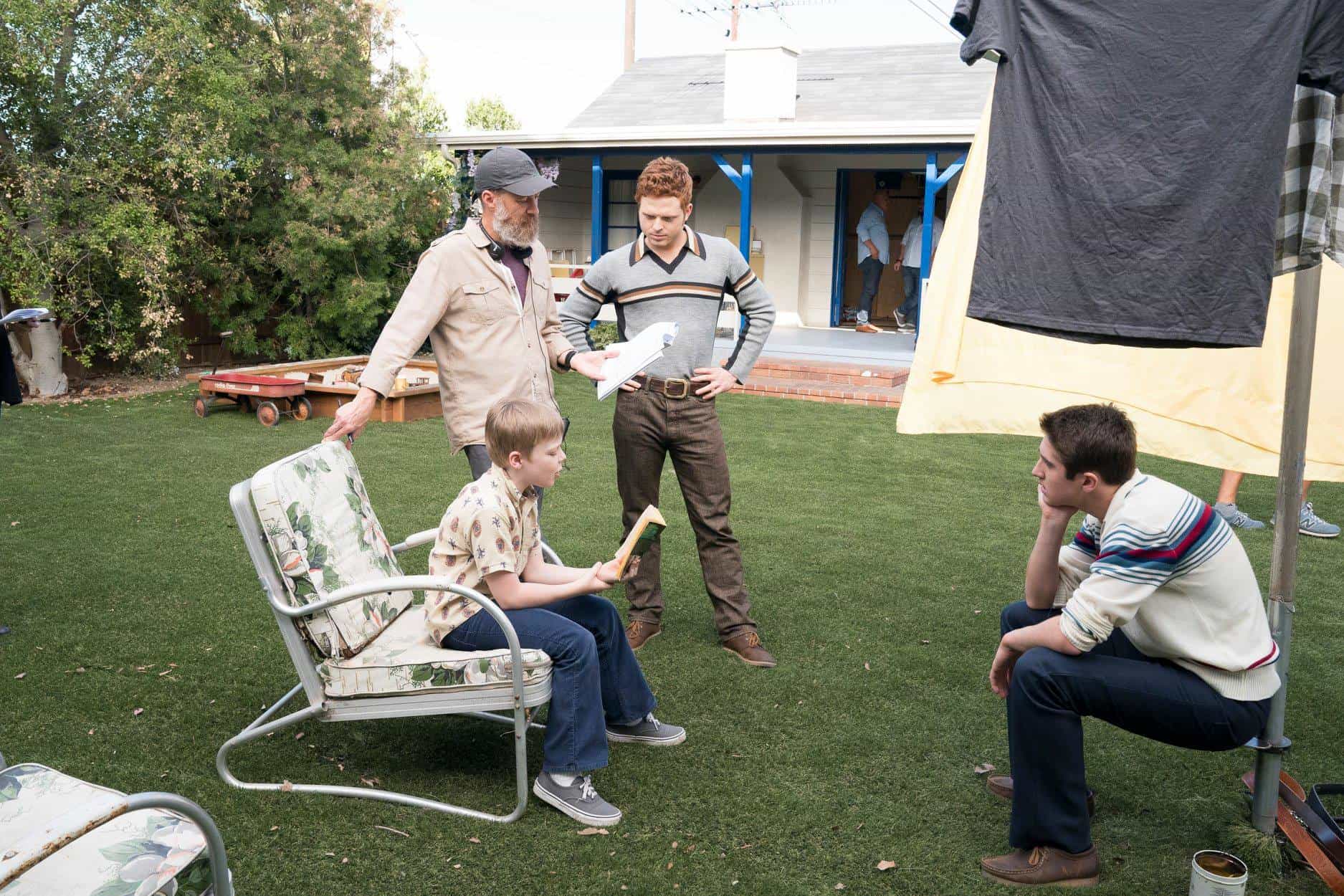 A group of people sitting at a park