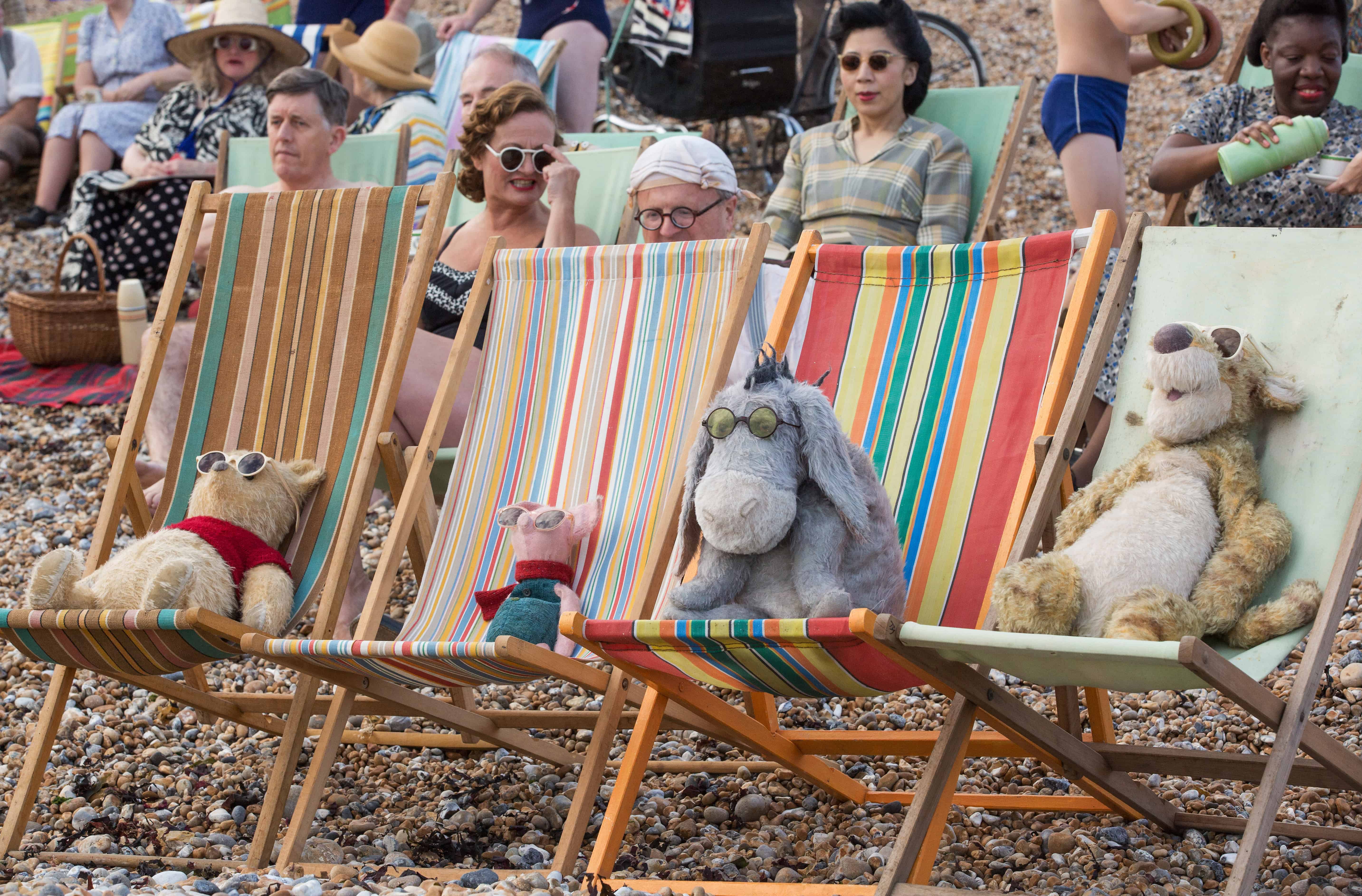 A group of stuffed animals sitting on top of a wooden chair