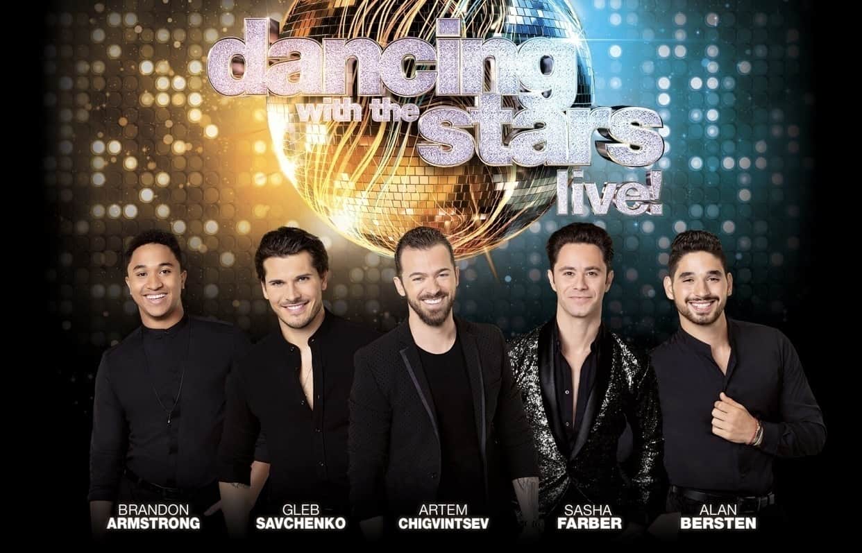 A person standing in front of Gleb Savchenko, Artem Chigvintsev posing for a photo, with Dance Lesson
