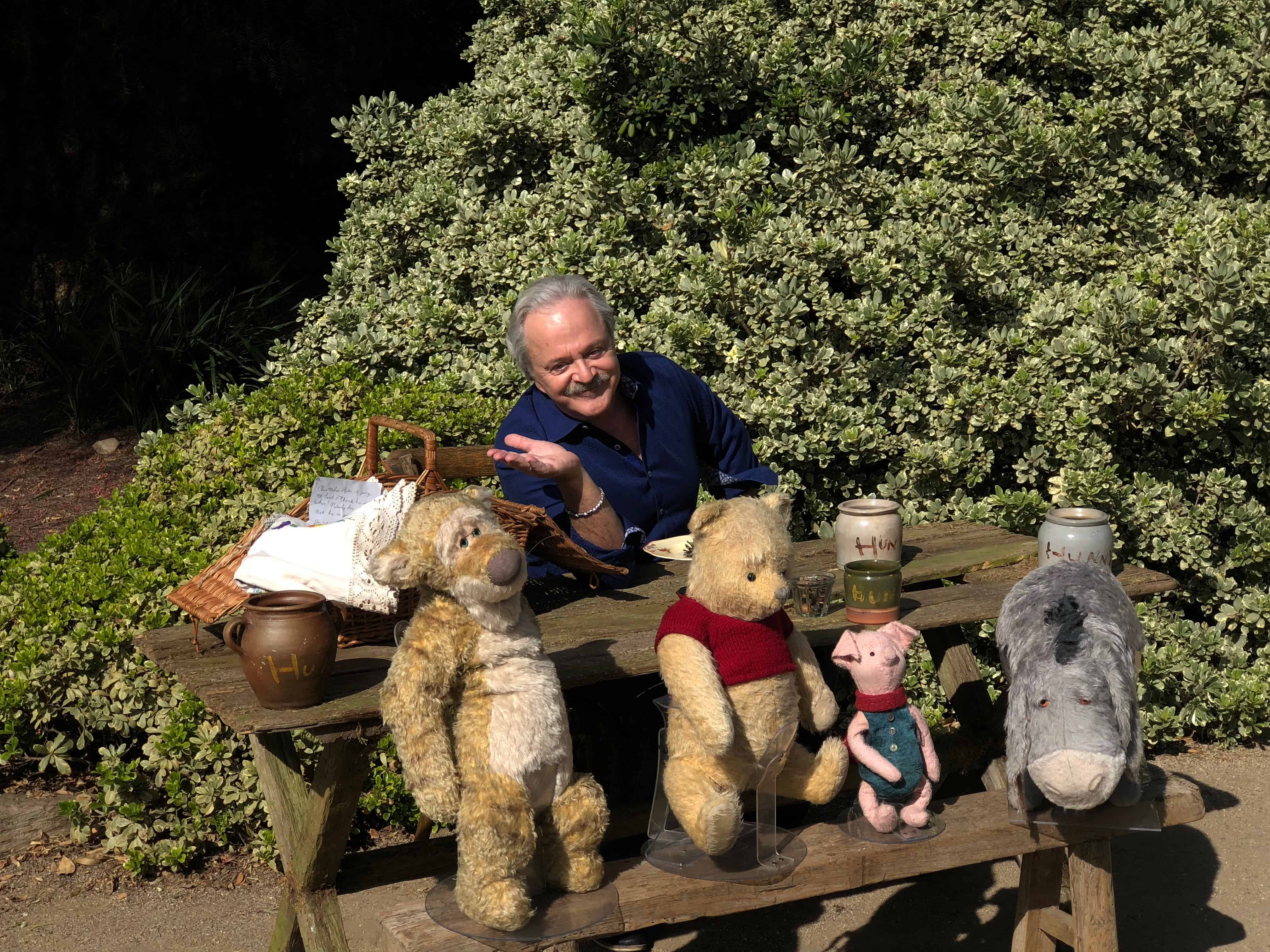 A group of stuffed animals sitting on a bench