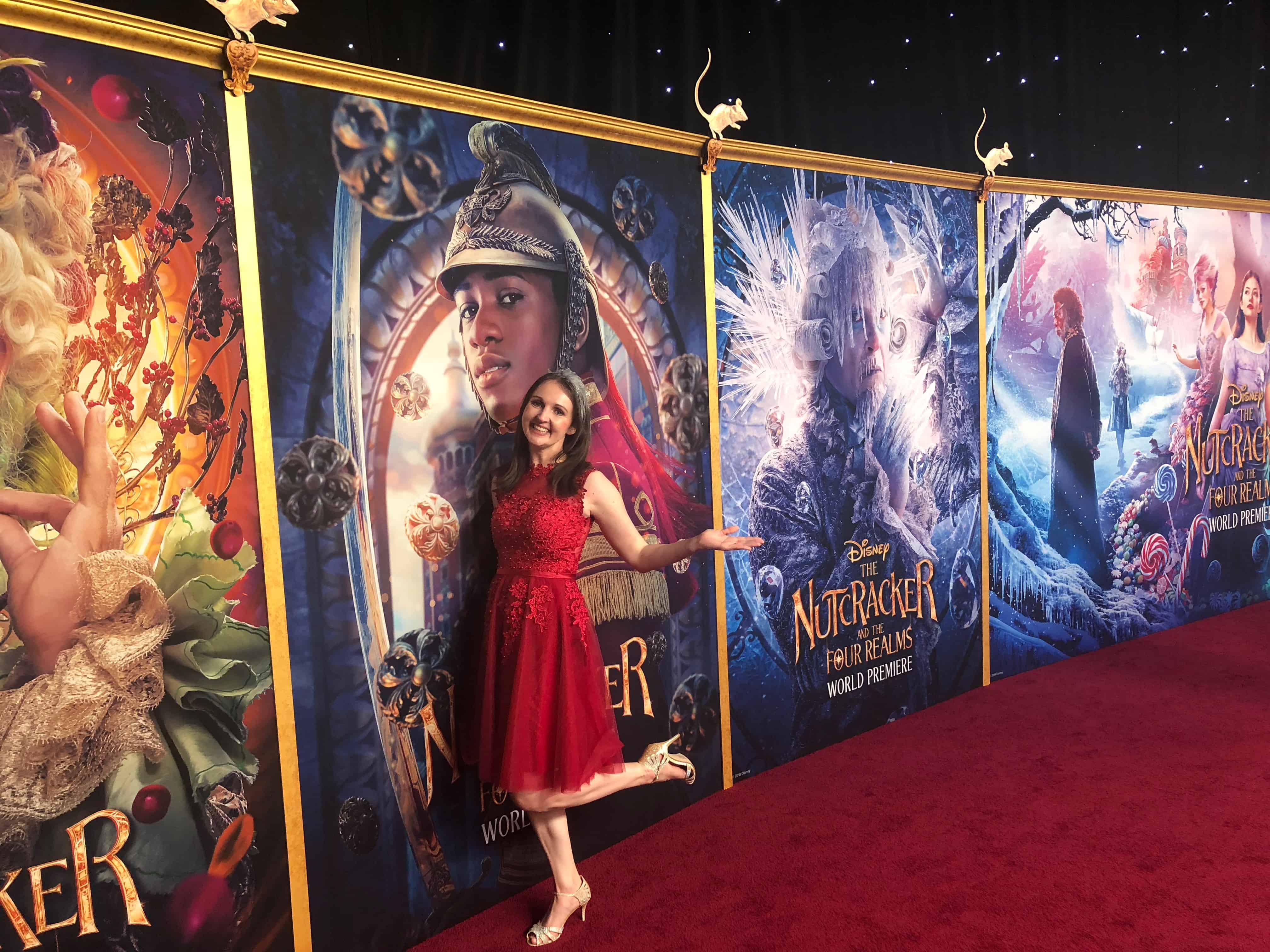 A person standing in front of a red carpet wall