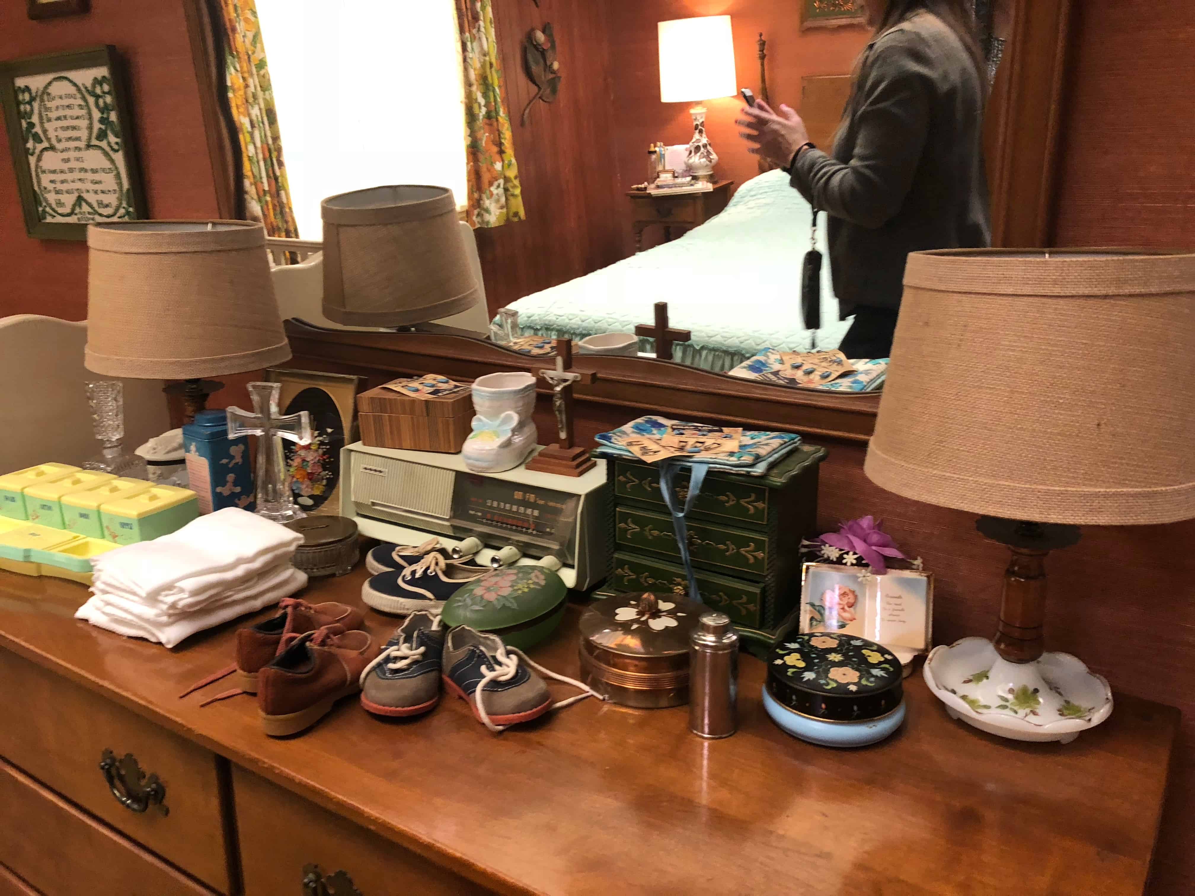 A person standing in front of a table, with Kids Are Alright