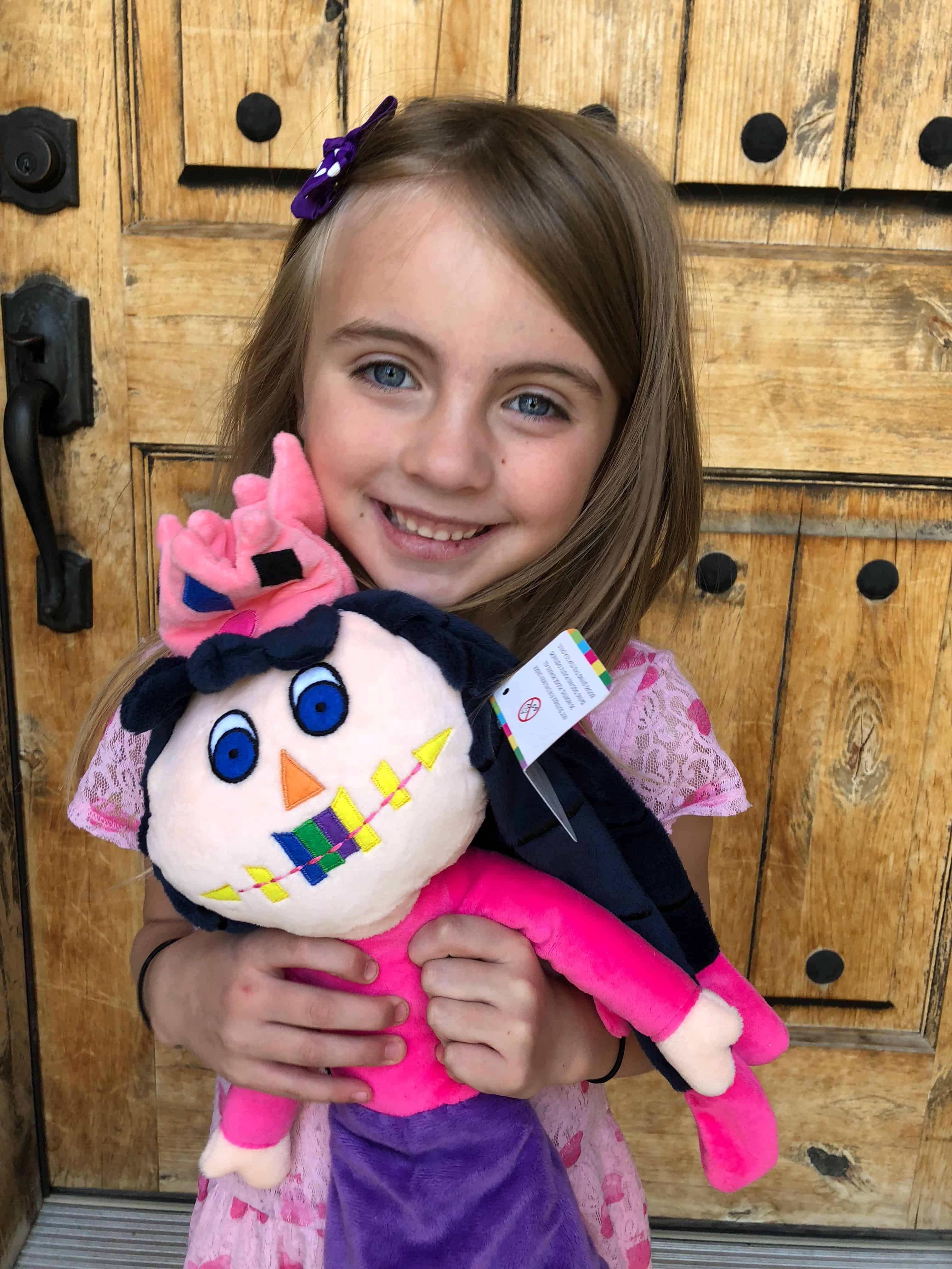 A little girl holding a toy