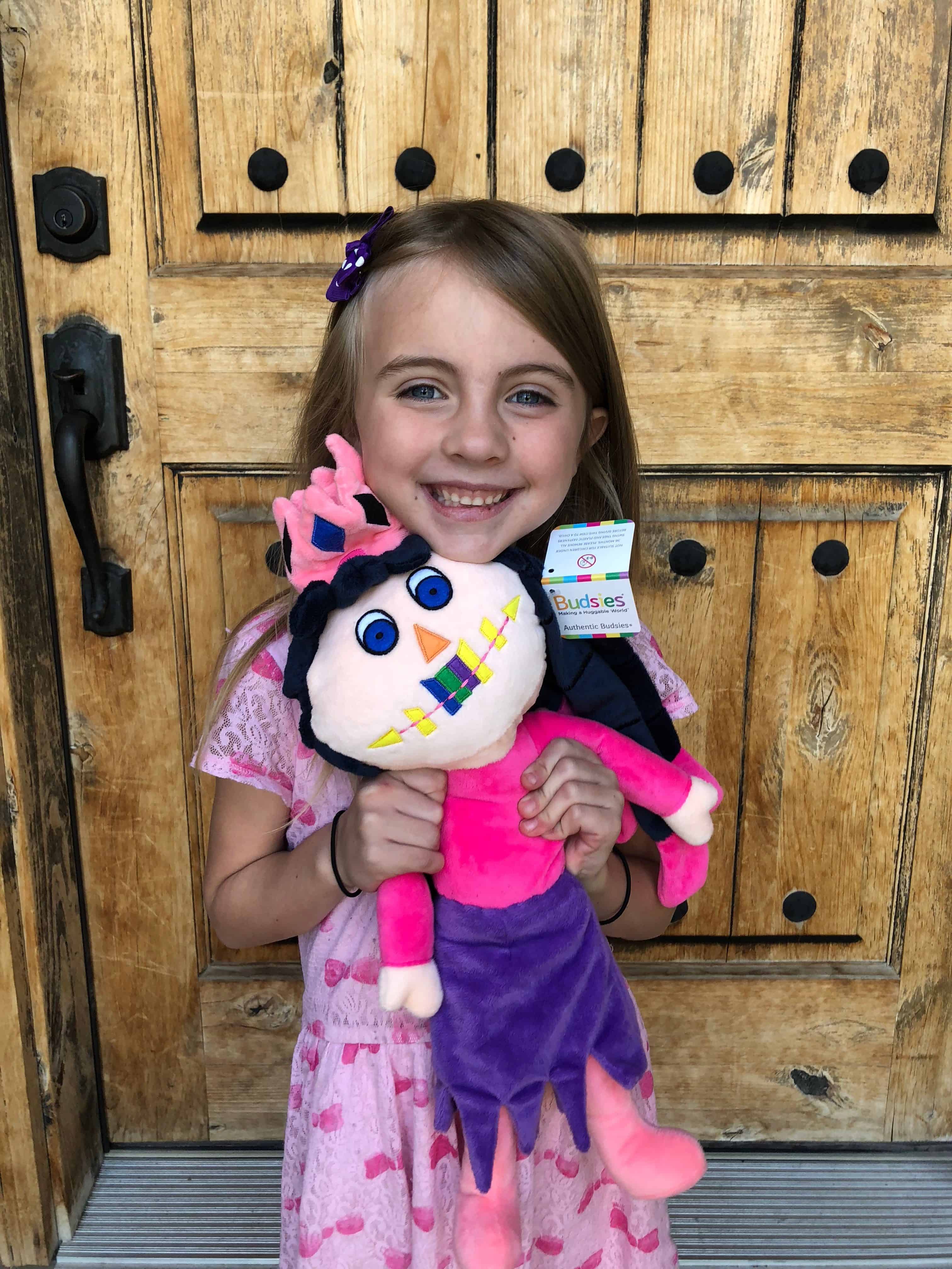 A little girl holding a teddy bear