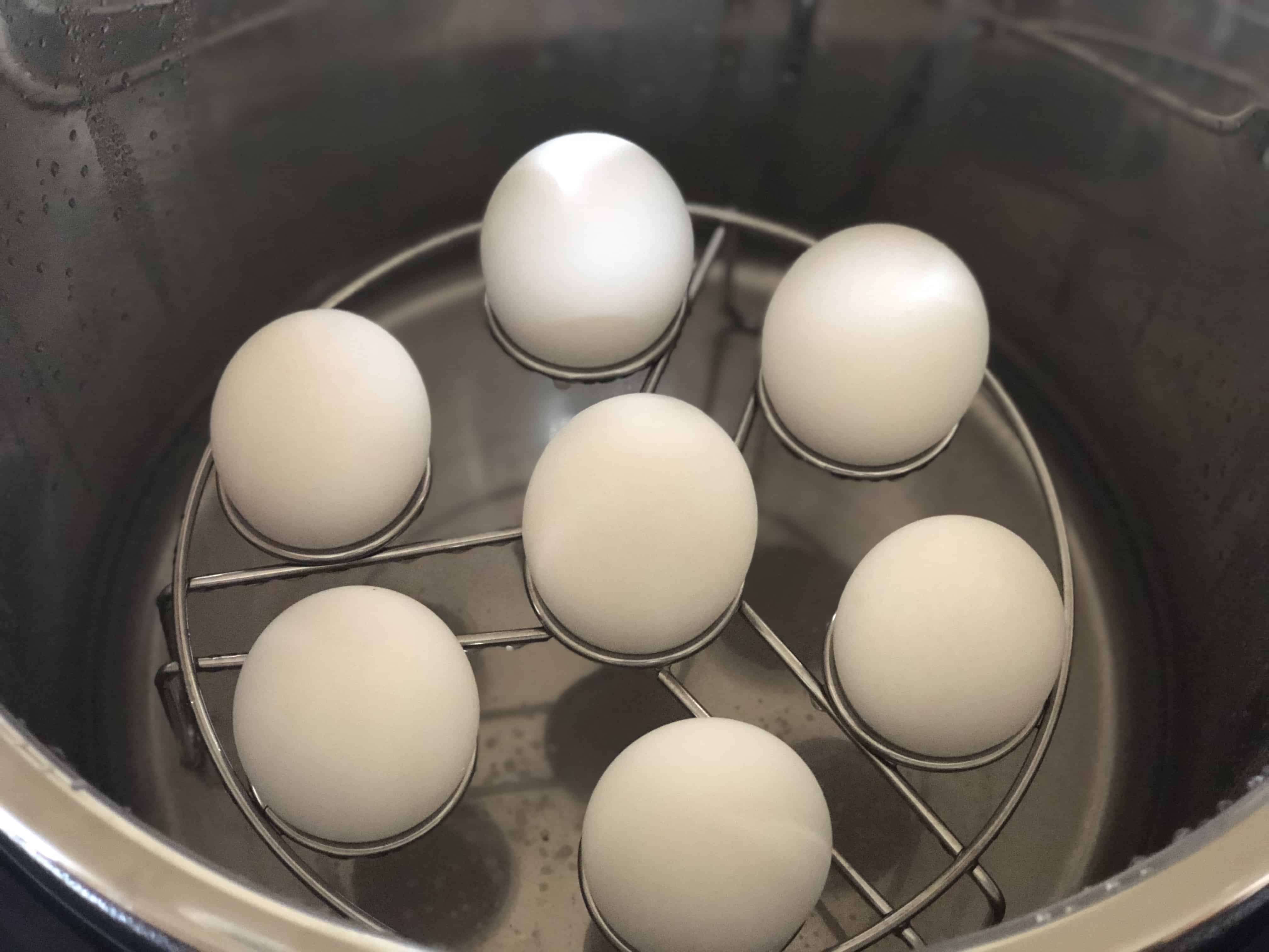An egg on top of a pan on a table, with Boiled egg