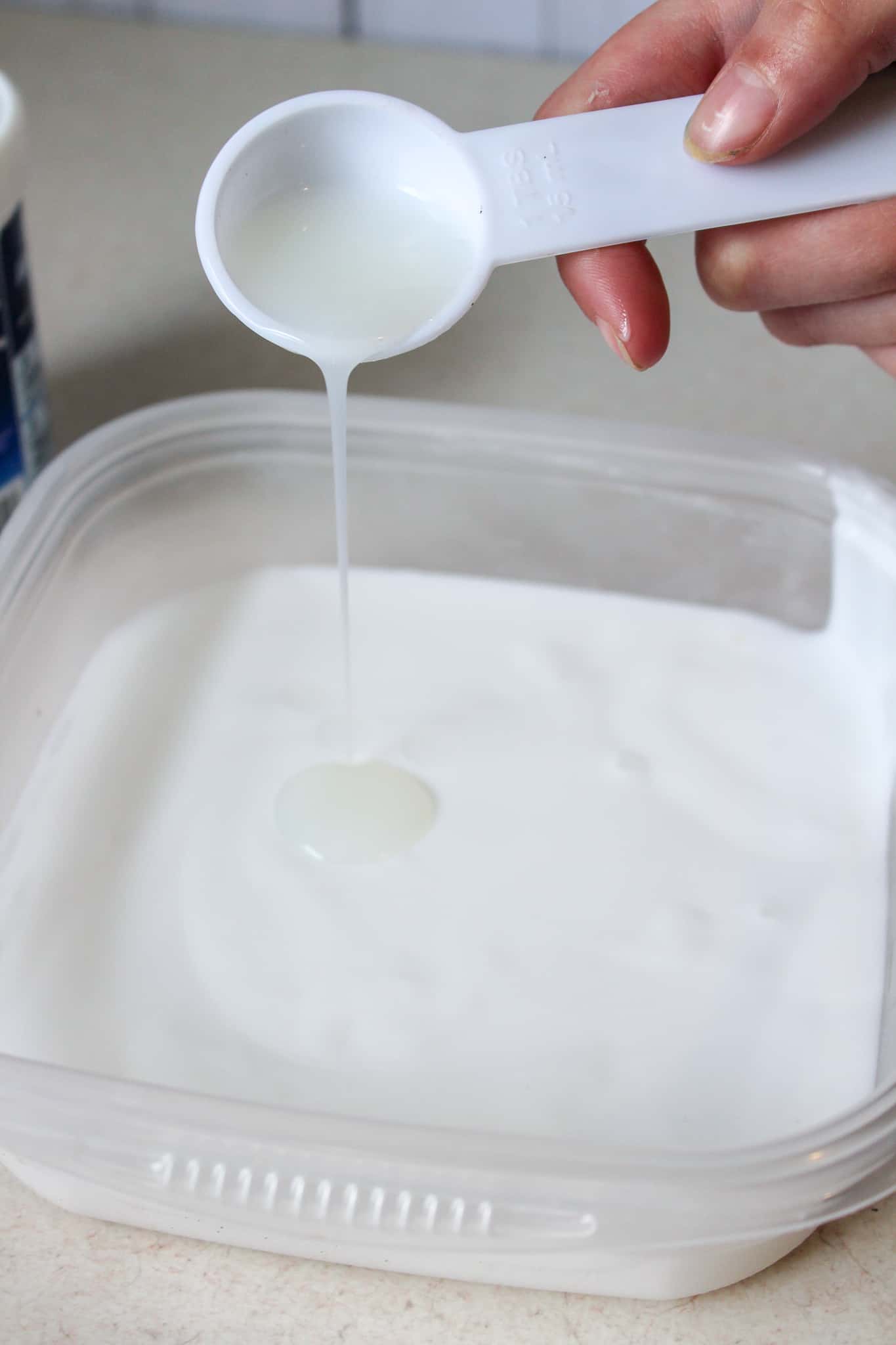A plastic container with a spoon