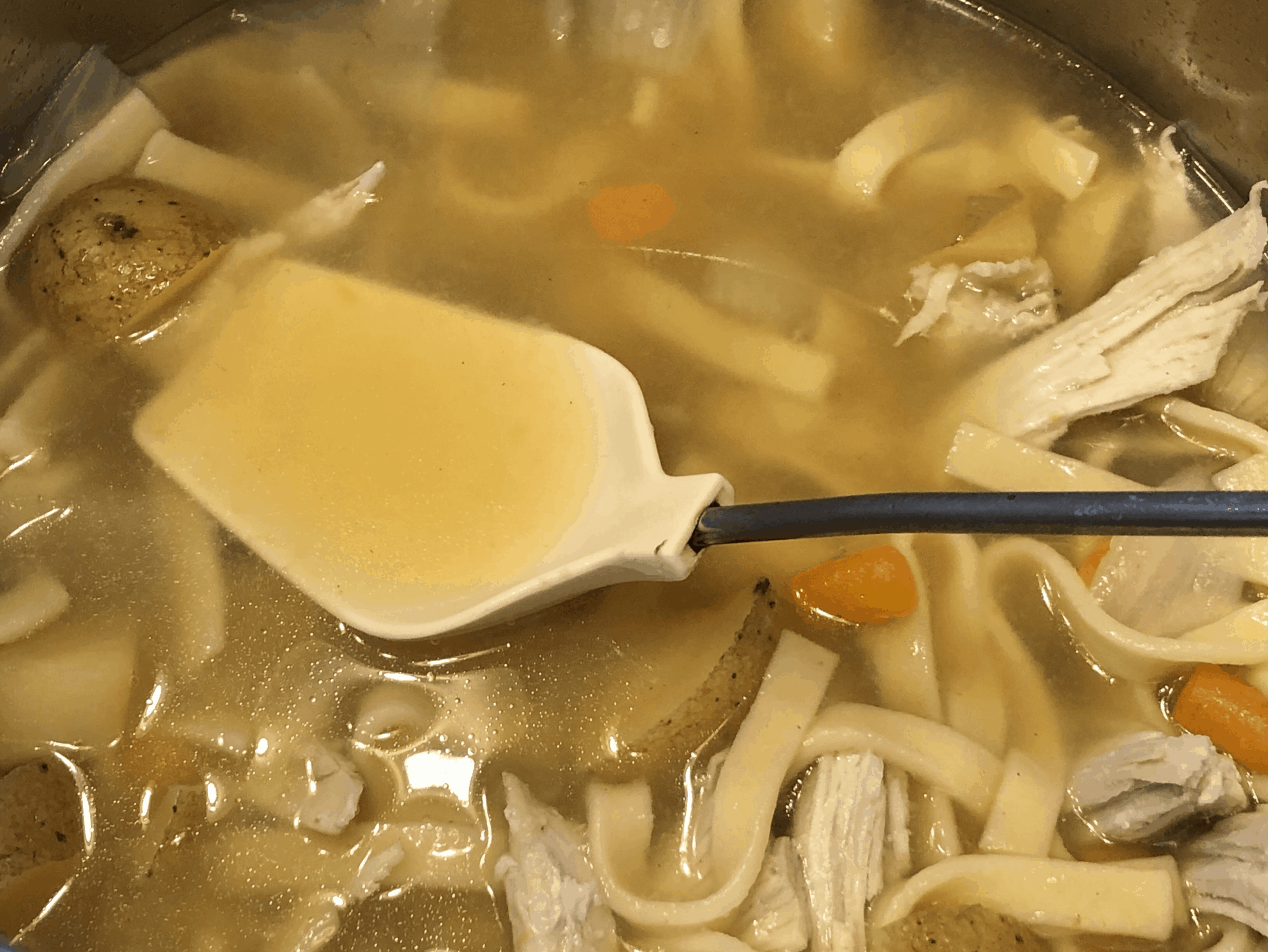 A bowl of soup and a spoon