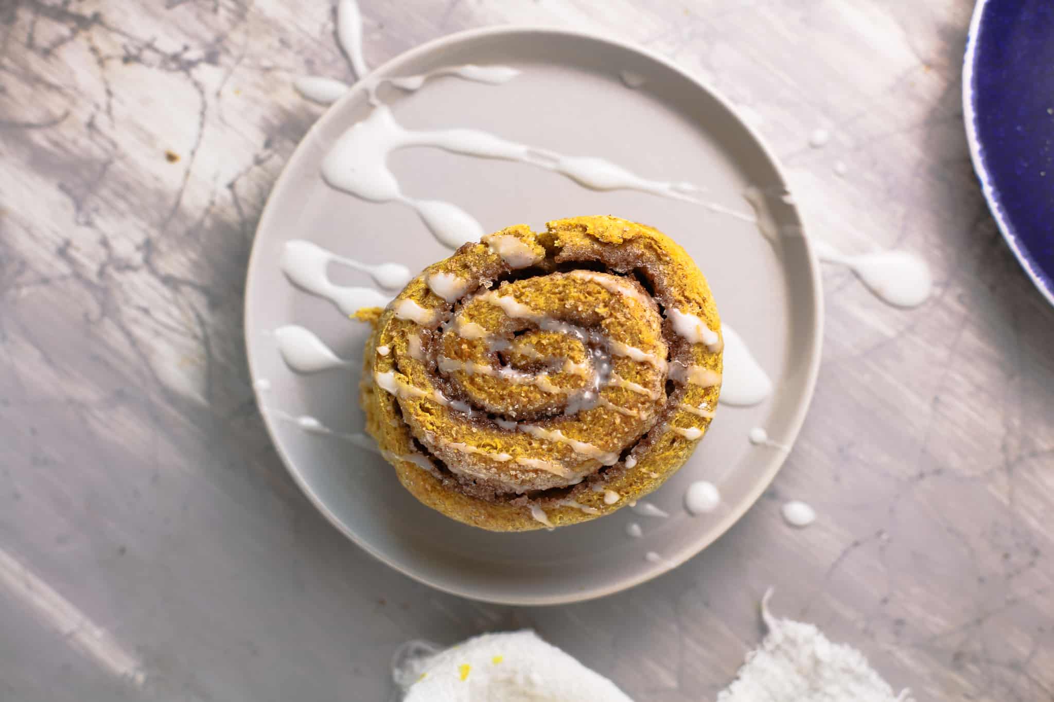 A cinnamon roll on a plate, with Baked goods