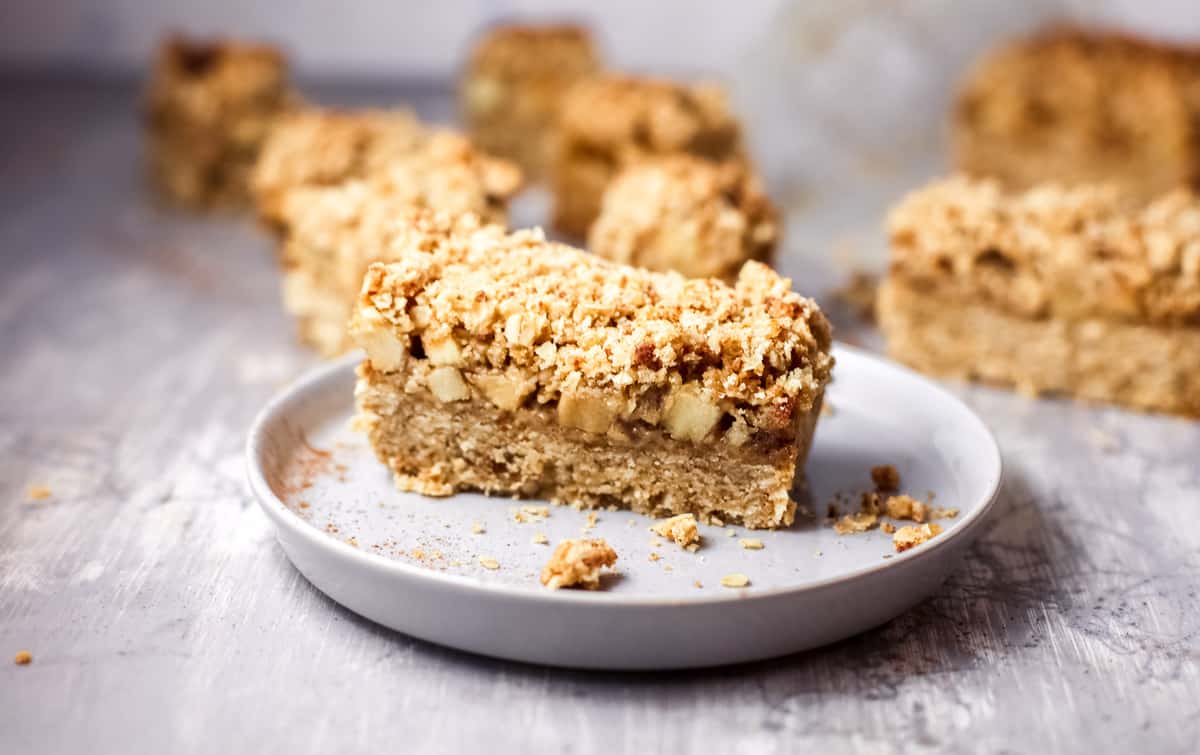A piece of cake on a plate, with Crumble