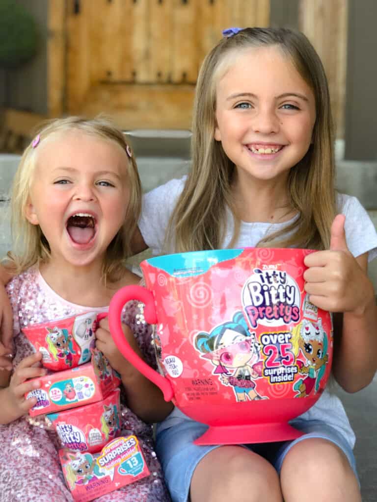 A little girl holding a large tea cup