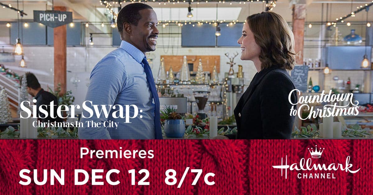 Promotional image for the "Sister Swap: Christmas in the City" Hallmark Channel movie, featuring two smiling actors, with air date and time information.