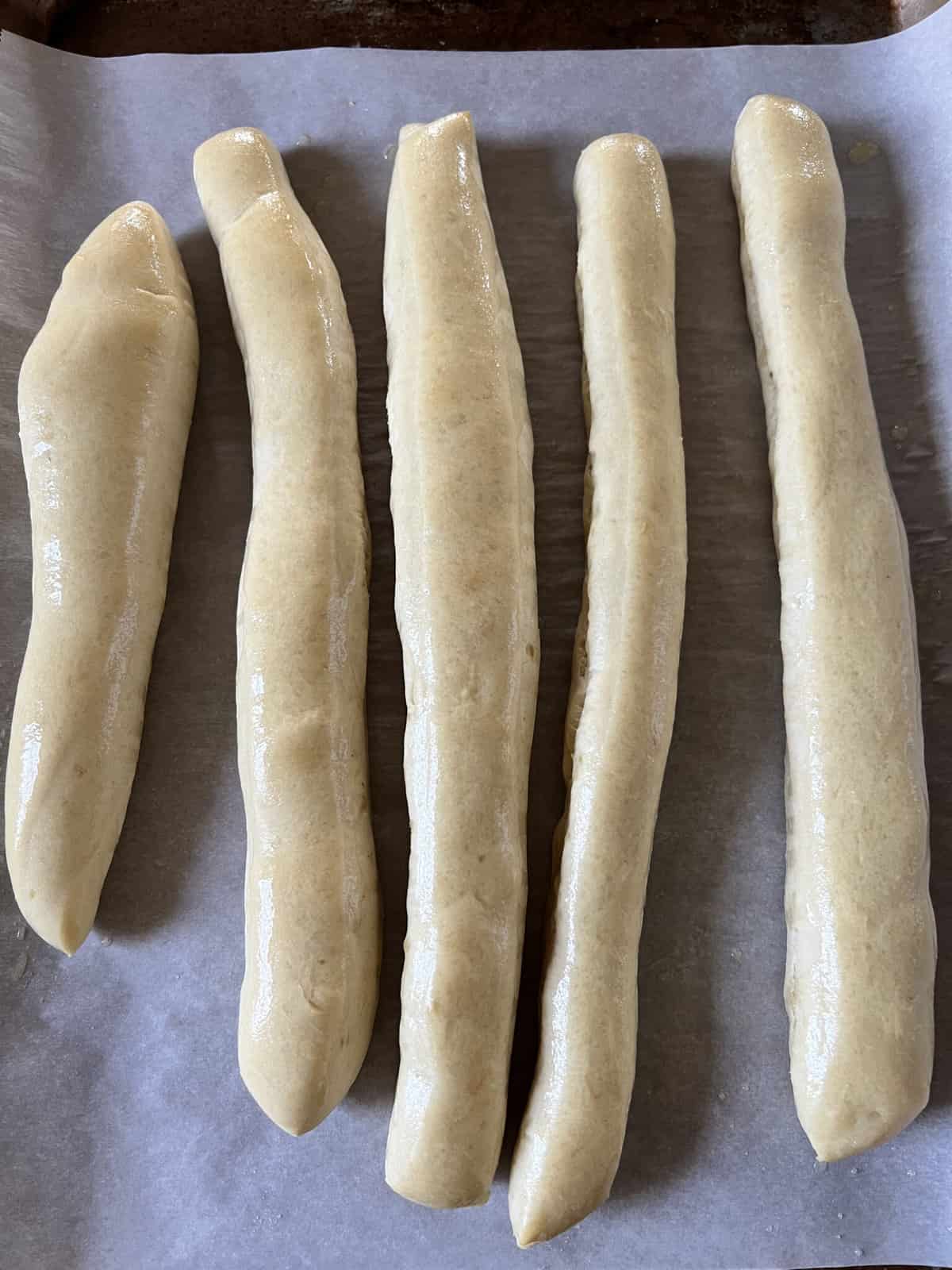Homemade Bread Machine Breadsticks on a cookie sheet.
