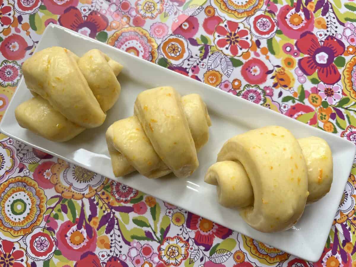 three oranges rolls on white plate