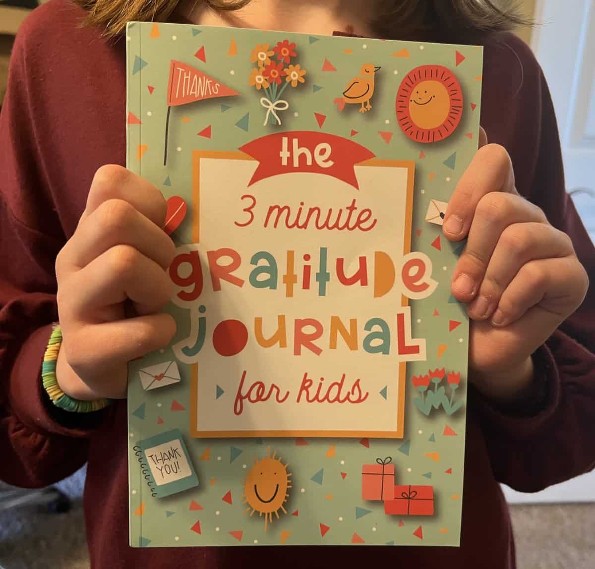 girl holding gratitude journal