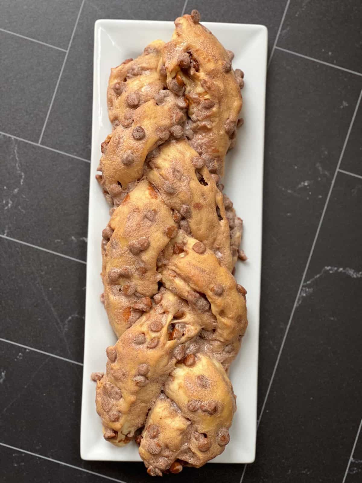 Braided Cinnamon Chip bread on white plate.