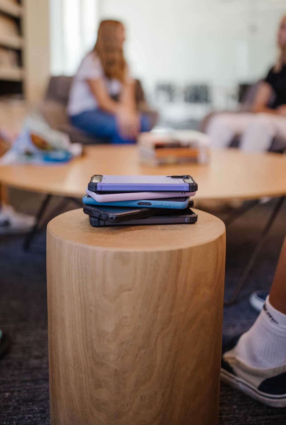 kids put their Best smartphones with parental controls for kids in a pile and are talking