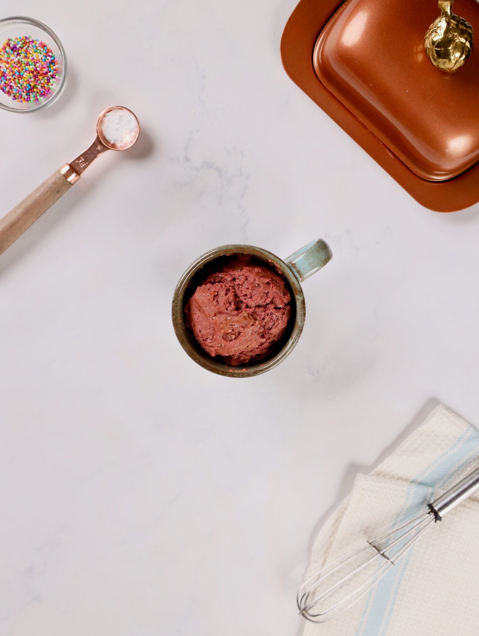 Mug filled with rich red velvet cake batter