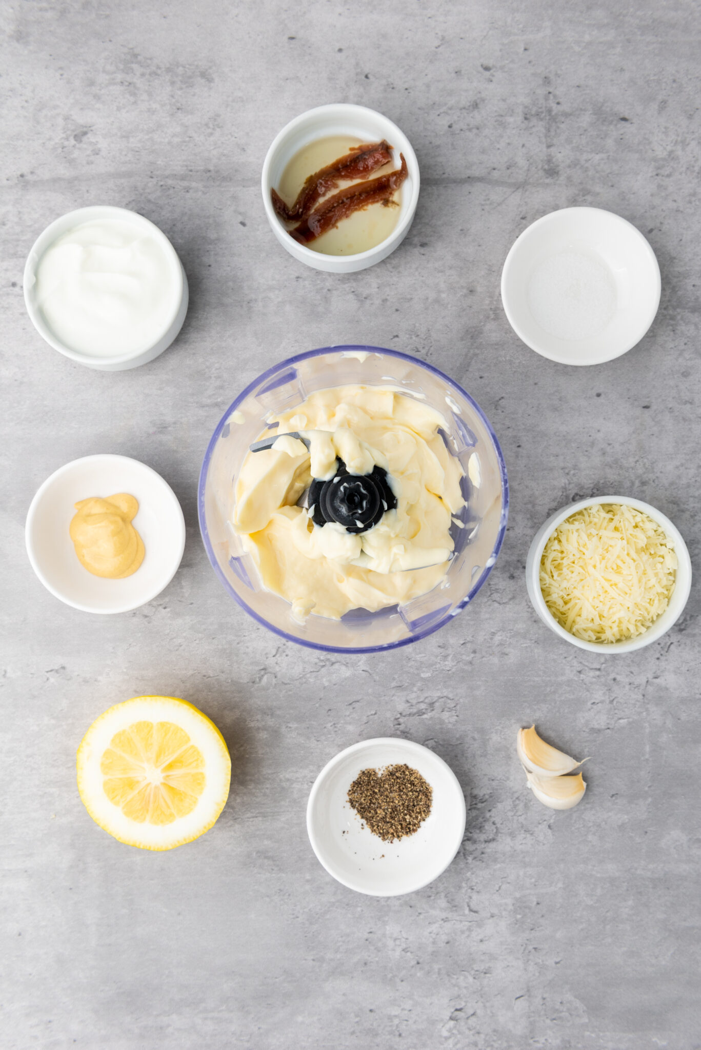 Adding a cup of creamy mayonnaise into the food processor