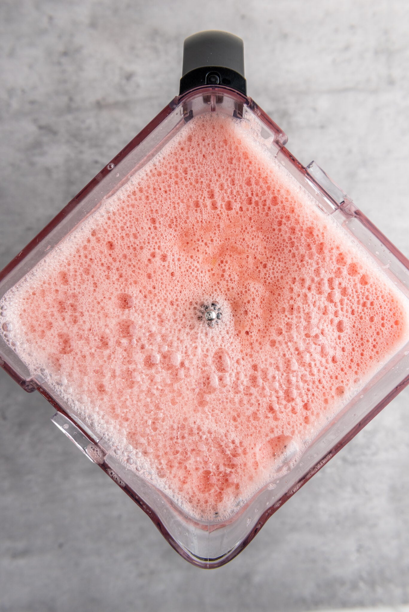 Blender in action, turning cubes into a smooth juice.
