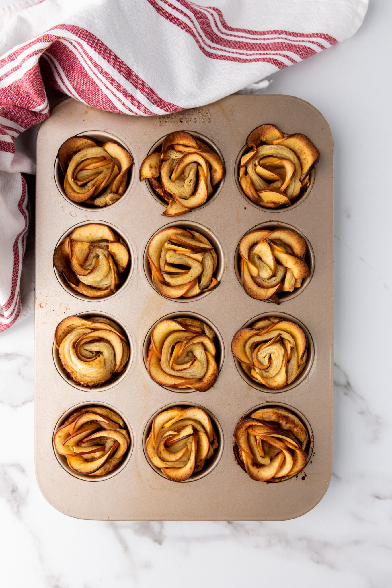 cooked multiple baked apple roses already in the muffin tray.