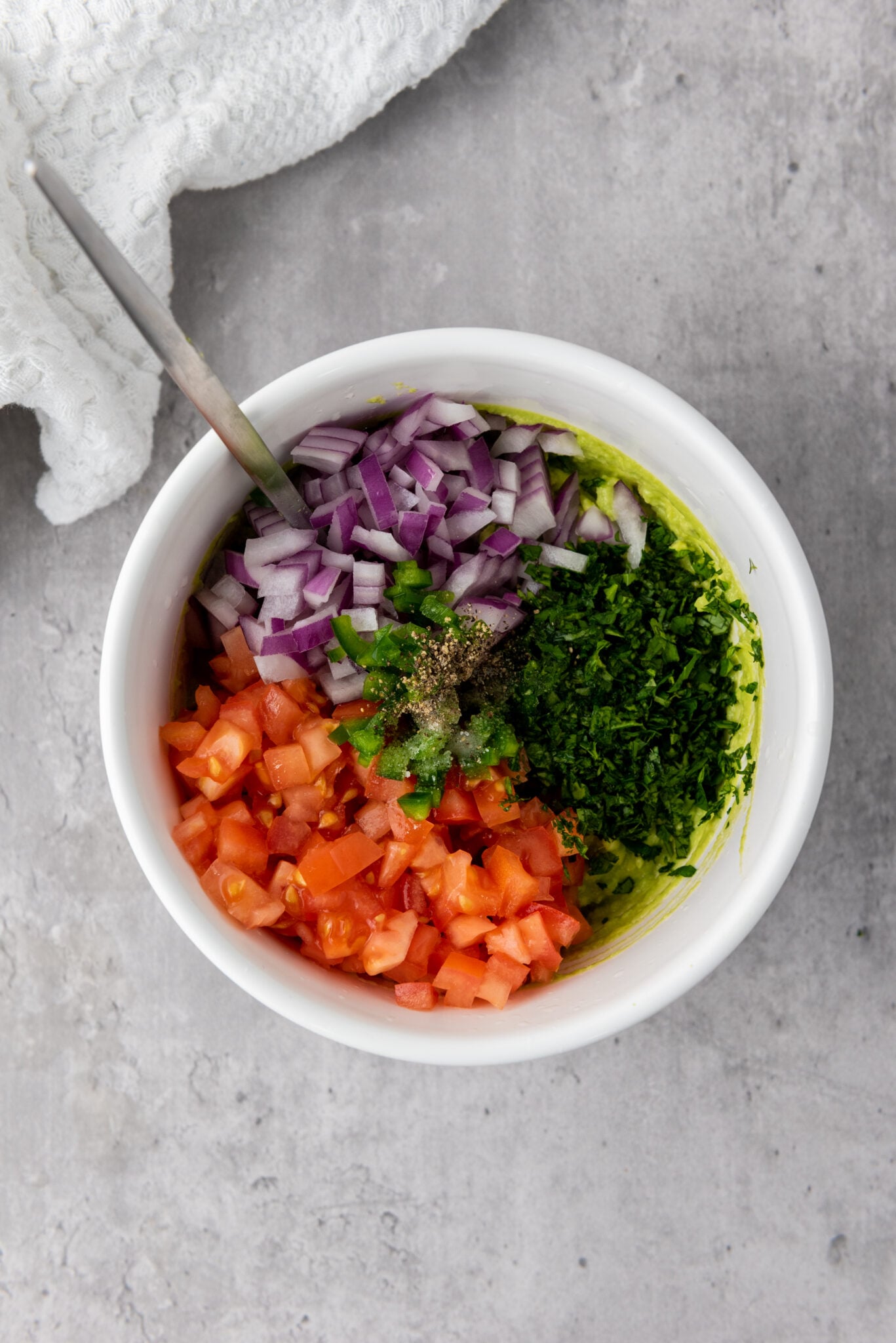 Bowl of guacamole ingredients ready to be mixed together.